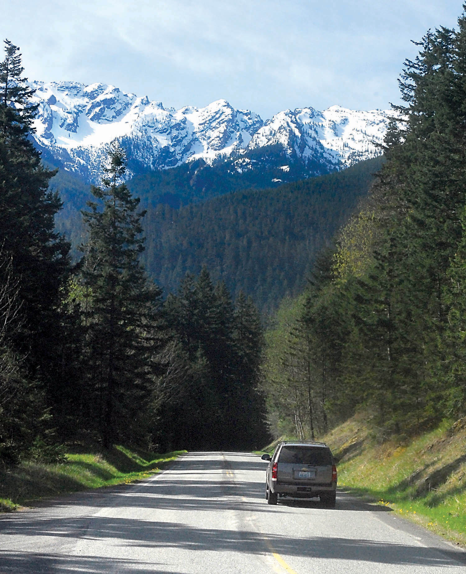 A car makes it way up Hurricane Ridge Road beneath a snow-covered Klahhane Ridge in Olympic National Park south of Port Angeles earlier this month. Hurricane Ridge has been named the most popular tourist attraction in the state in a Parade magazine article. — Keith Thorpe/Peninsula Daily News