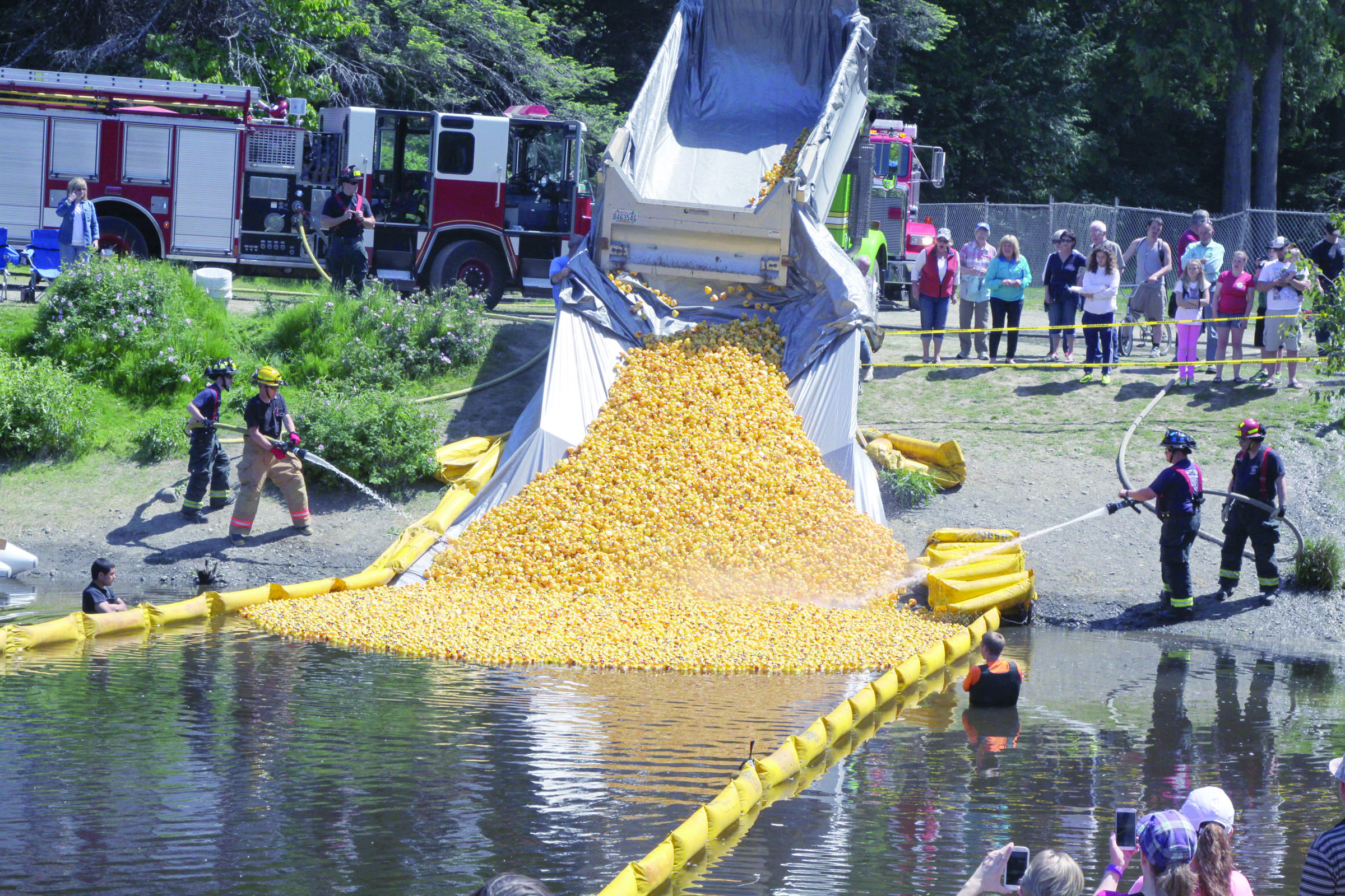 The 25th Great Olympic Peninsula Duck Derby gets underway in Port Angeles on Sunday with a little help from the city fire department. Dave Logan/for Peninsula Daily News