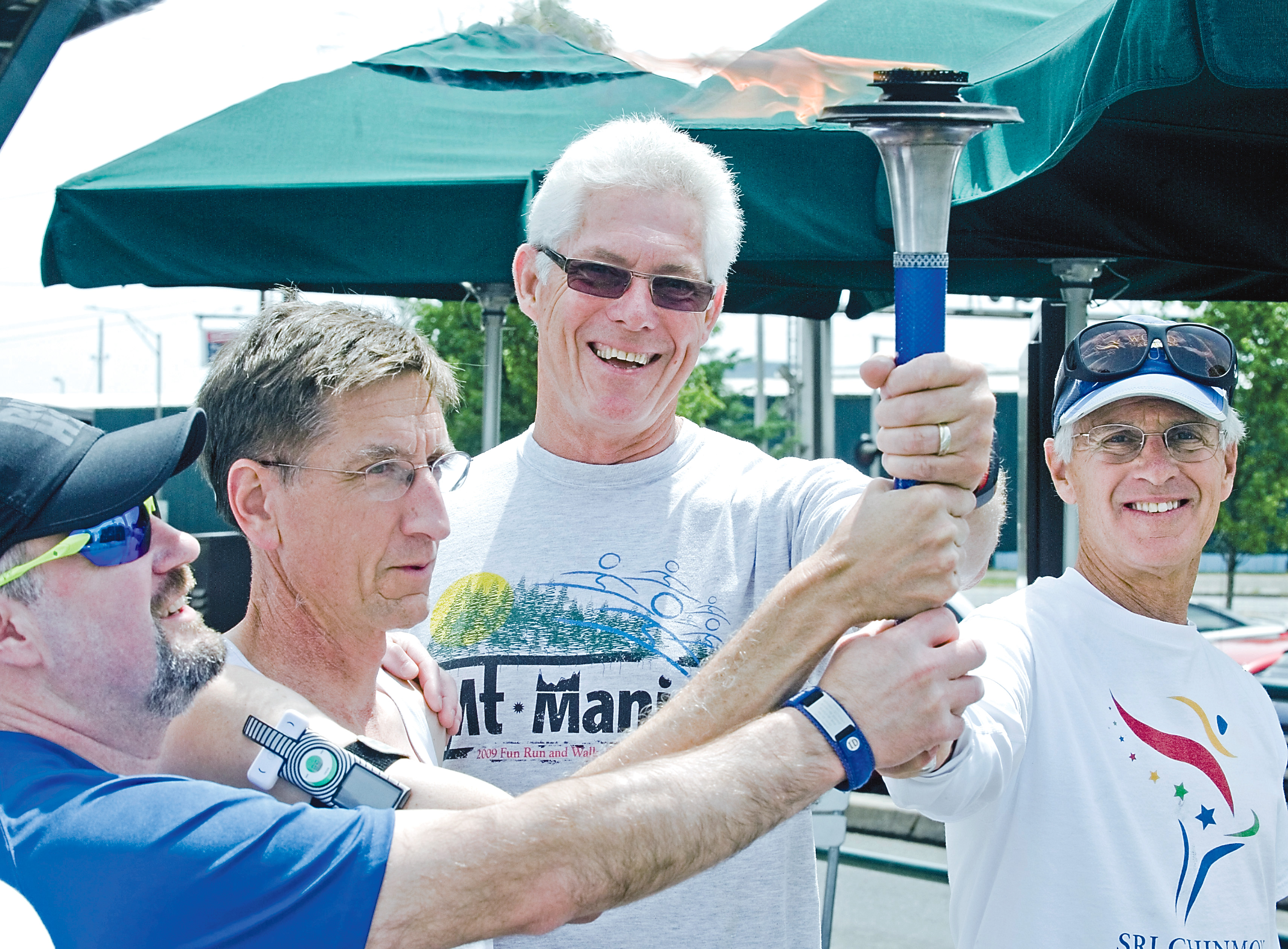 Members of the Cowlitz Valley Runners Club accept the torch for the Sri Chinmoy Oneness-Home Peace Run as it passed through Southwest Washington on Sunday. Runners will be on the North Olympic Peninsula on Thursday. John Markon/The [Longview] Daily News