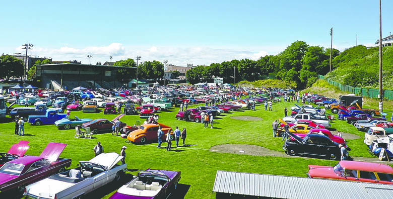 People walk among the many cars on display at the 2013 Rakers Car Show in Port Townsend. The show rolls into town at Memorial Field