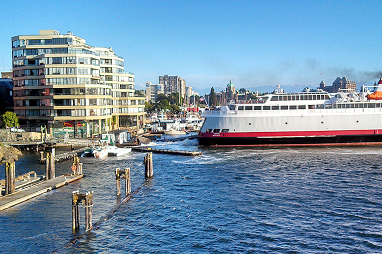 The MV Coho pulls away from a damaged floatplane dock in front of the Regent Hotel in Victoria on Wednesday night. CVT Two/Vancouver Island via KOMO News