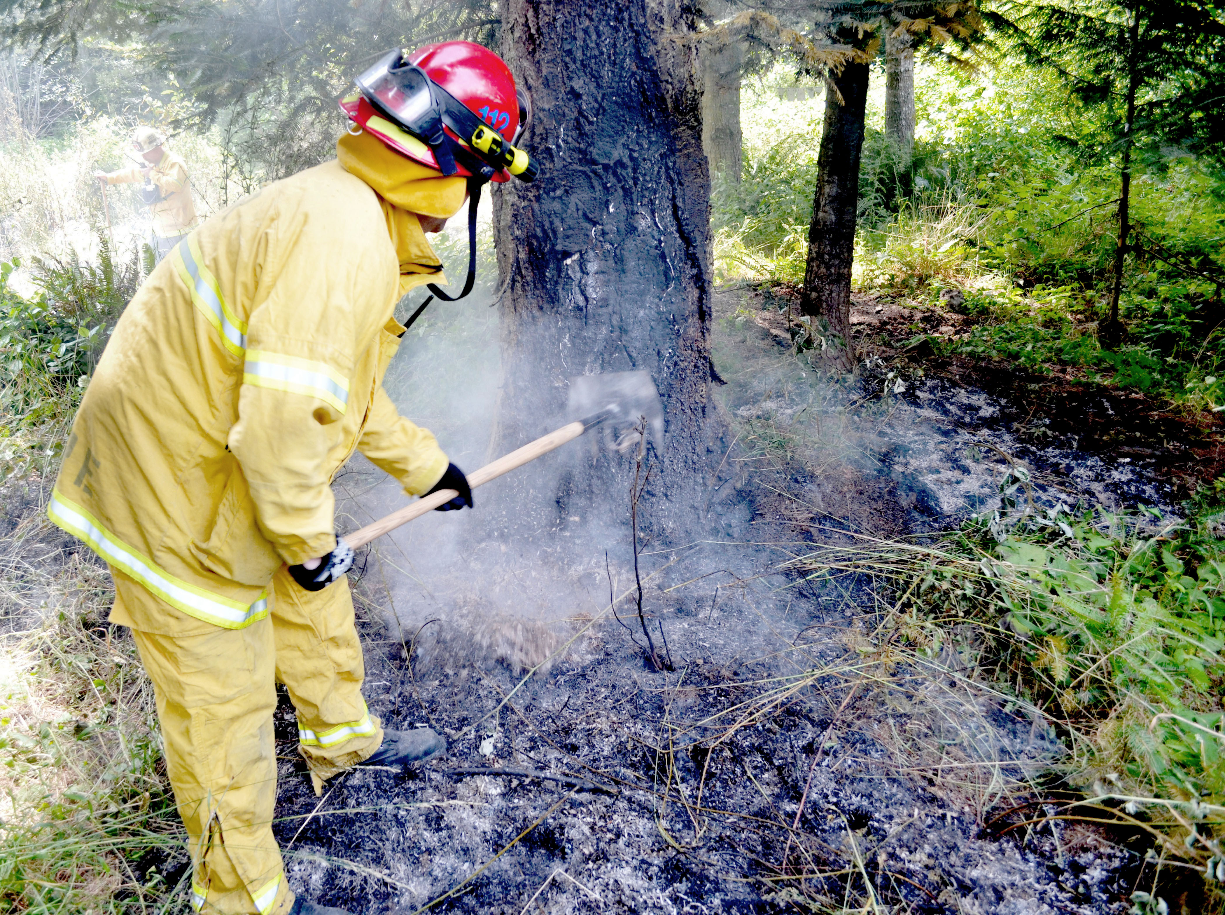 A Jefferson County Fire-Rescue firefighter works one of the two Sunday brush fires.  —Photo by Bill Beezley/East Jefferson Fire-Rescue