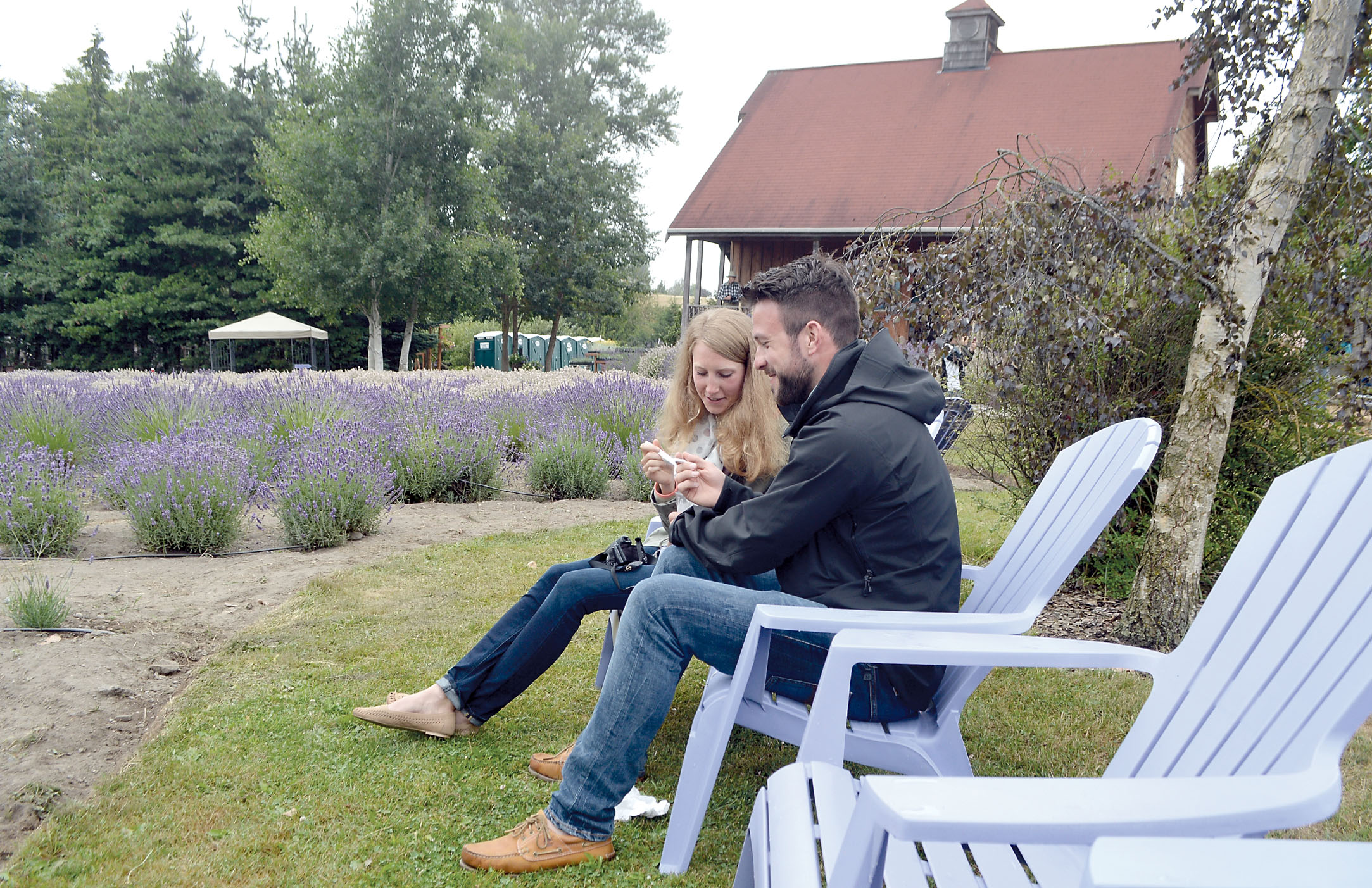 German tourists Frieda and Moritz Guhrke enjoy lavender-and-white-chocolate ice cream with custard in garden chairs at Purple Haze Lavender Farm. —Photo by Joe Smillie/Peninsula Daily News