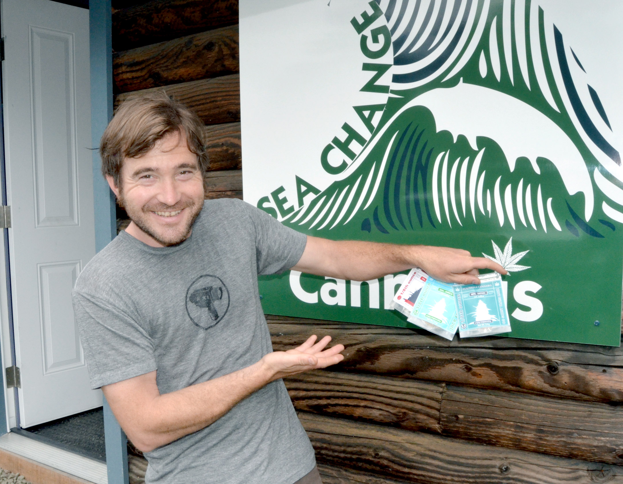 Sea Change Cannabis owner Greg Brotherton displays the three varieties of marijuana his store will begin selling at 10 a.m. Friday. Charlie Bermant/Peninsula Daily News