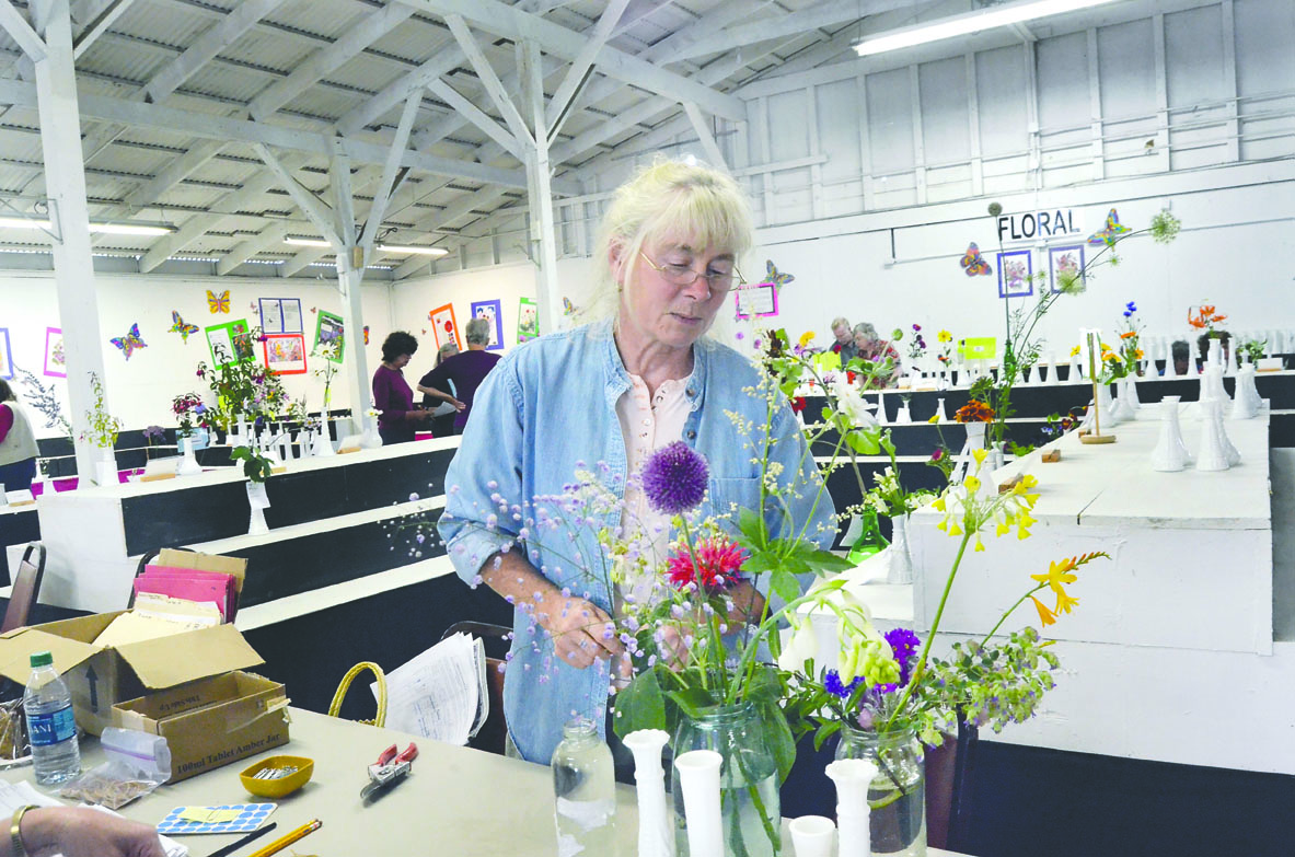 Erica Iseminger prepares her floral entries for judging at the Jefferson County Fair in Port Townsend. Charlie Bermant/Peninsula Daily News