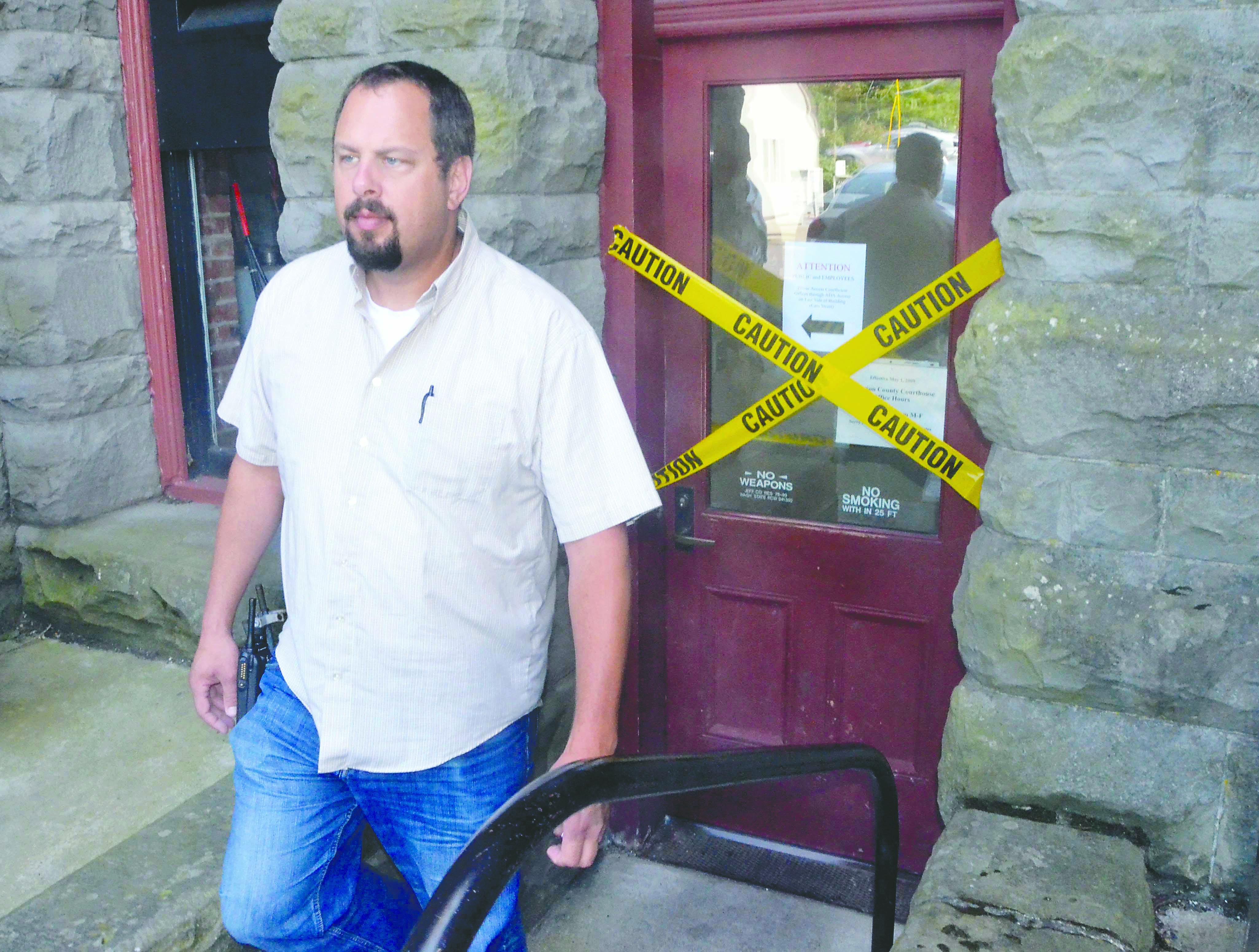 Port Townsend Police Detective Jason Greenspane stands at the rear door of the Jefferson County Courthouse on Wednesday