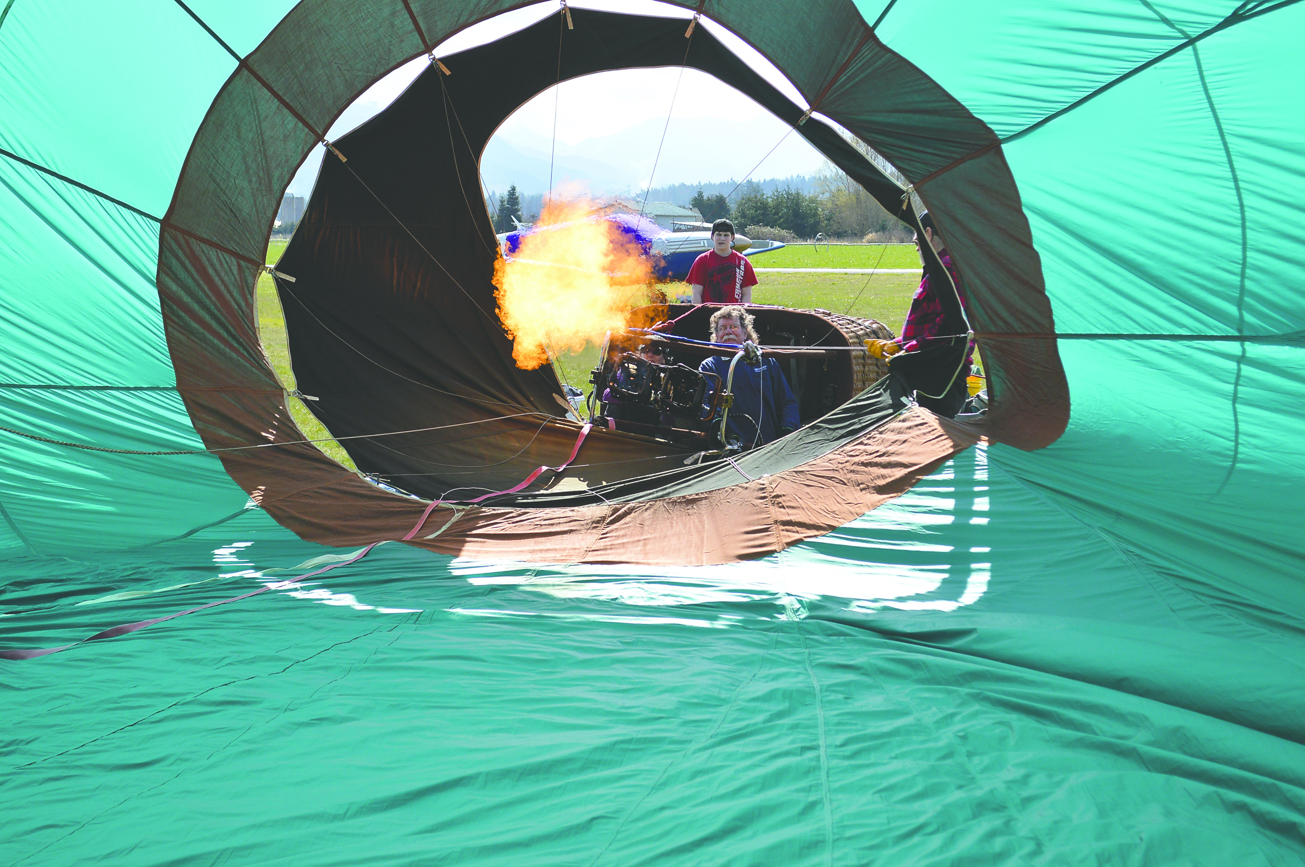 Flames shoot hot air into a hot air balloon owned by Capt. Crystal Stout’s Morning Star Balloon Co.  -- Photo by Joe Smillie/Peninsula Daily News