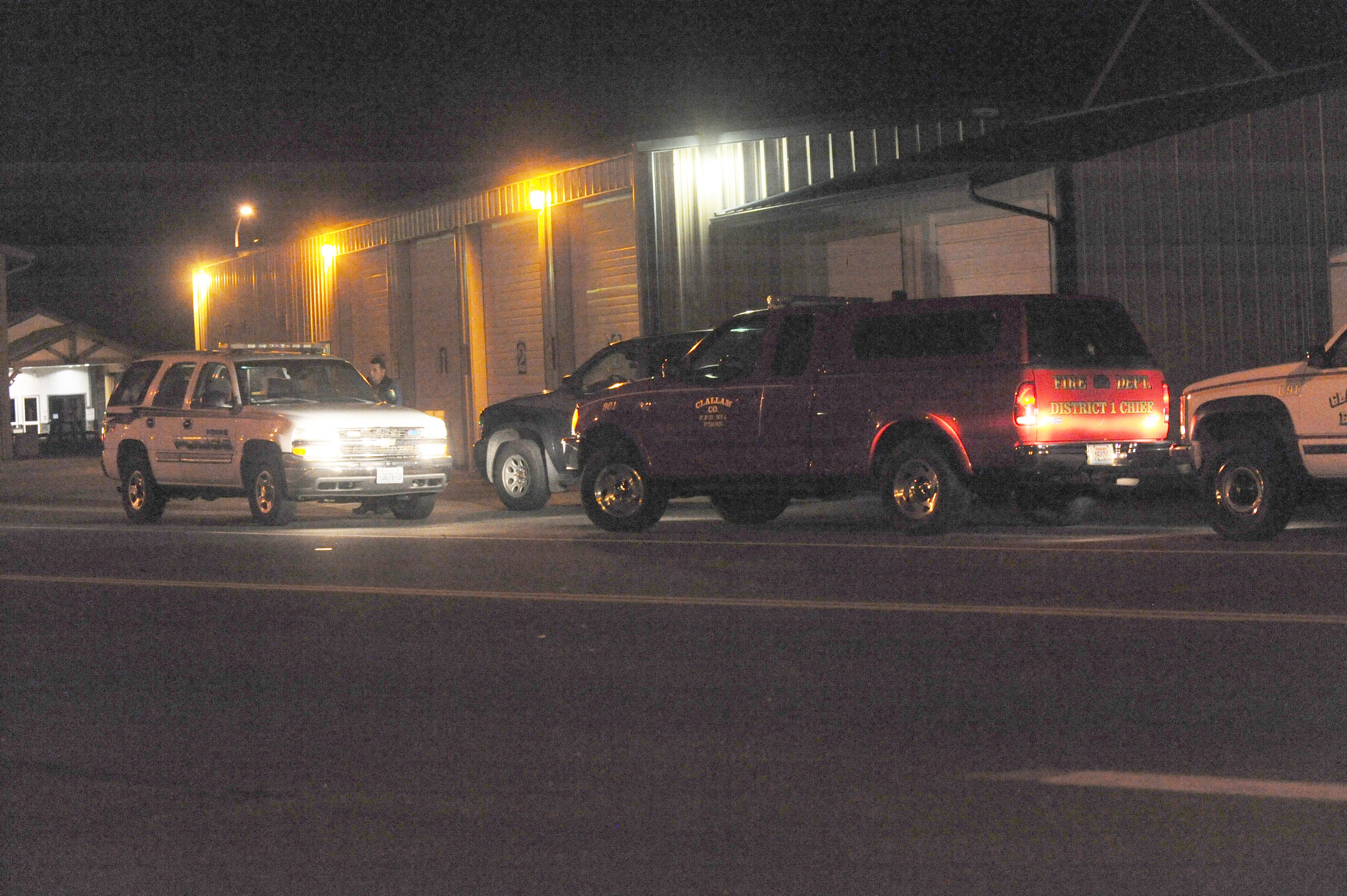 Law enforcement officers and Forks Fire Department personnel gather at the Forks Ambulance headquarters across from the Forks hospital Sunday evening. Lonnie Archibald/for Peninsula Daily News