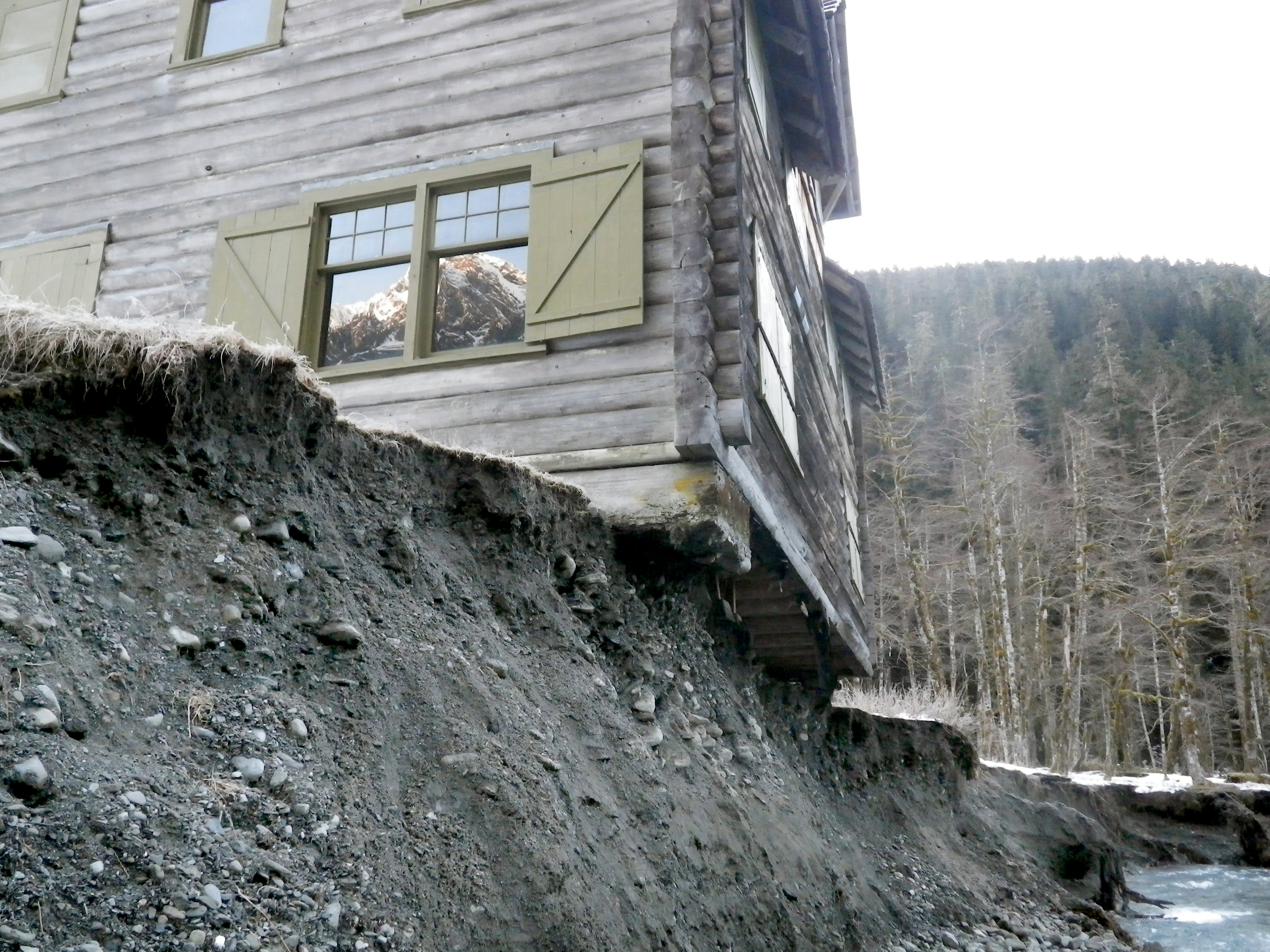 The Enchanted Valley Chalet is shown precariously over the bank of the changing East Fork Quinault River last March. National Park Service photo