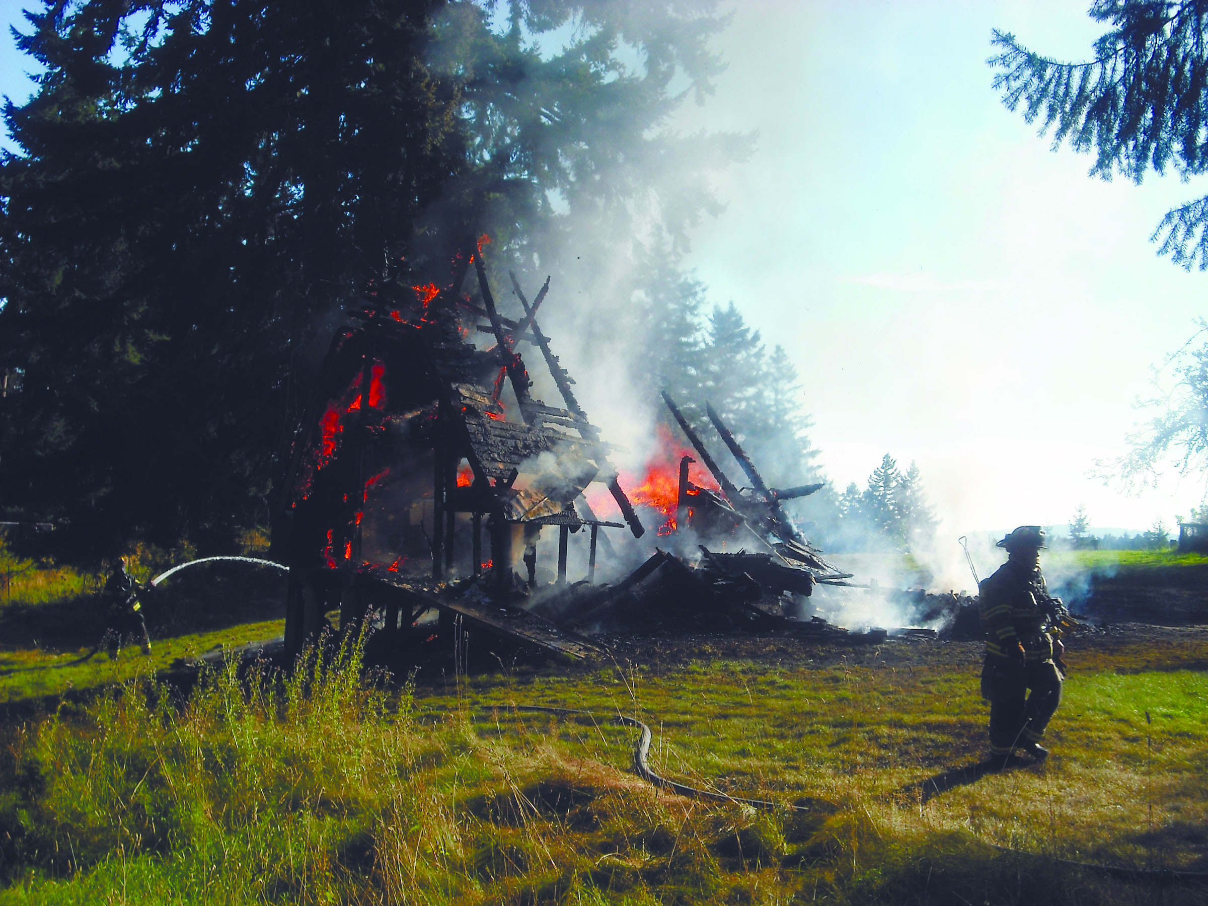 Fire razes an A-frame house on the historic Danz Ranch property in the Olympic Mountain foothills.  -- Photo by Margaret McKenzie/Peninsula Daily News