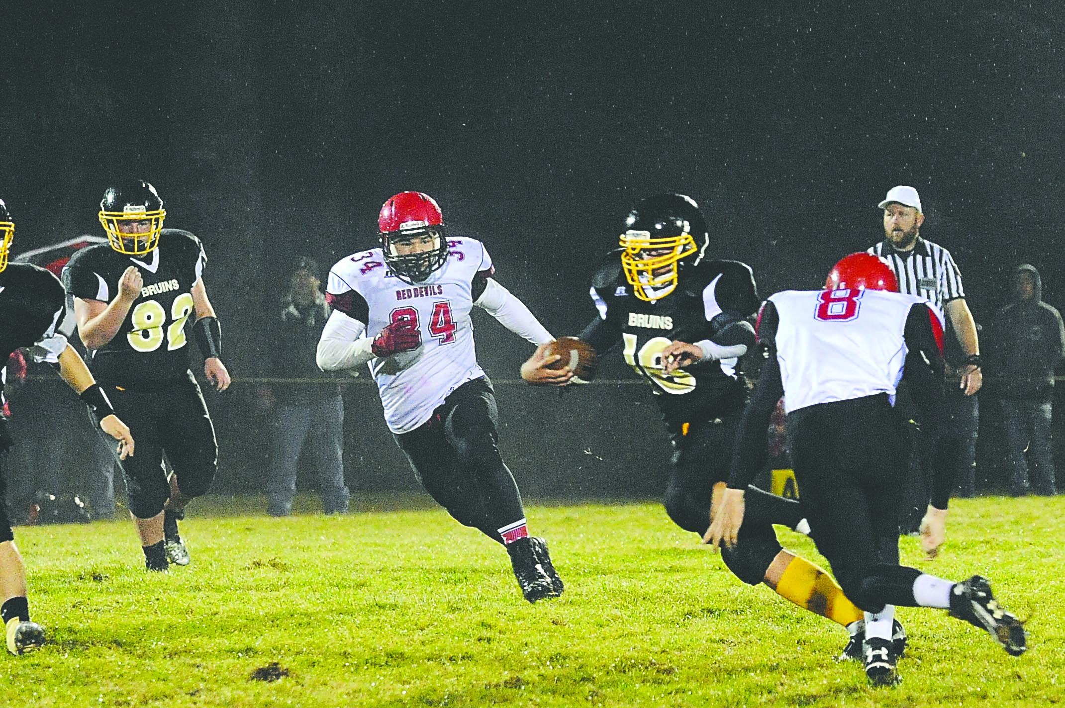 Clallam bay's Brian Smith (16) finds running room between Neah Bay's John Reamer (34) and Reggie Buttram (8). Lonnie Archibald/for Peninsula Daily News