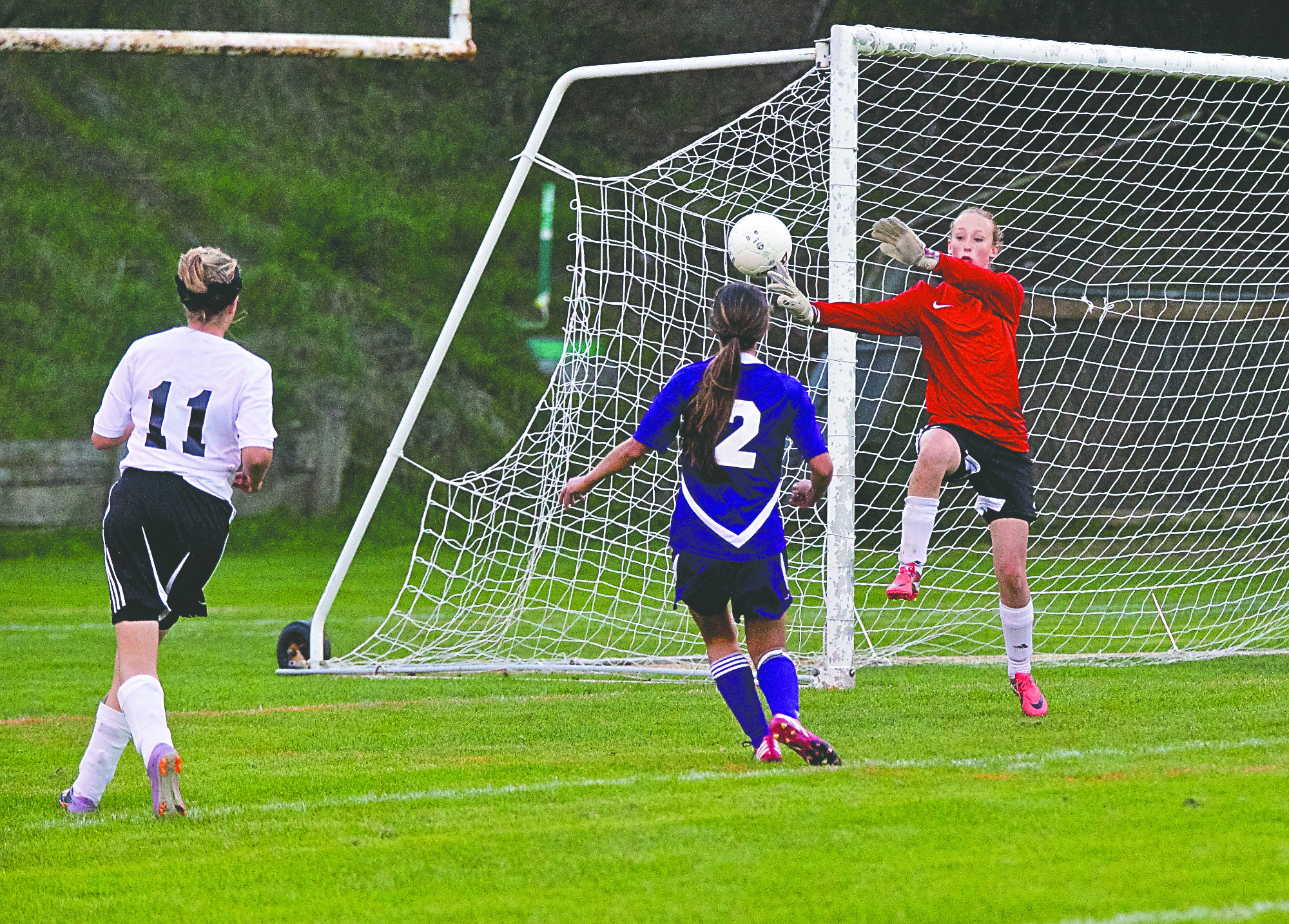 Port Townsend goalkeeper Malia Henderson deflects a shot on goal by Sequim's Nicole Anders (2) during an Olympic League game played at Memorial Field. Steve Mullensky/for Peninsula Daily News