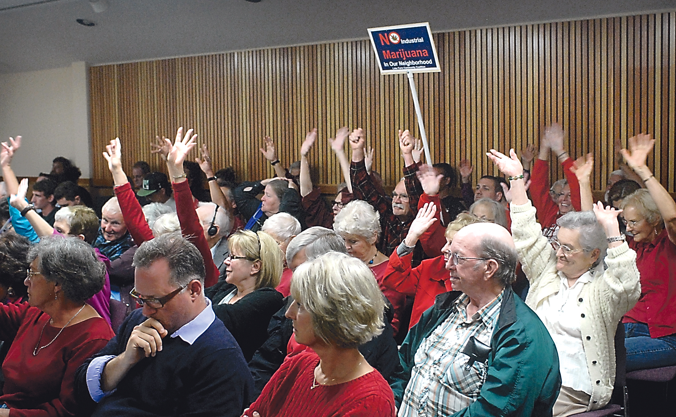 Opponents to marijuana grow operations in Clallam County wave hands instead of clapping in support of speakers during a public hearing Tuesday on the county's proposed interim zoning ordinances for marijuana production. Keith Thorpe/Peninsula Daily News