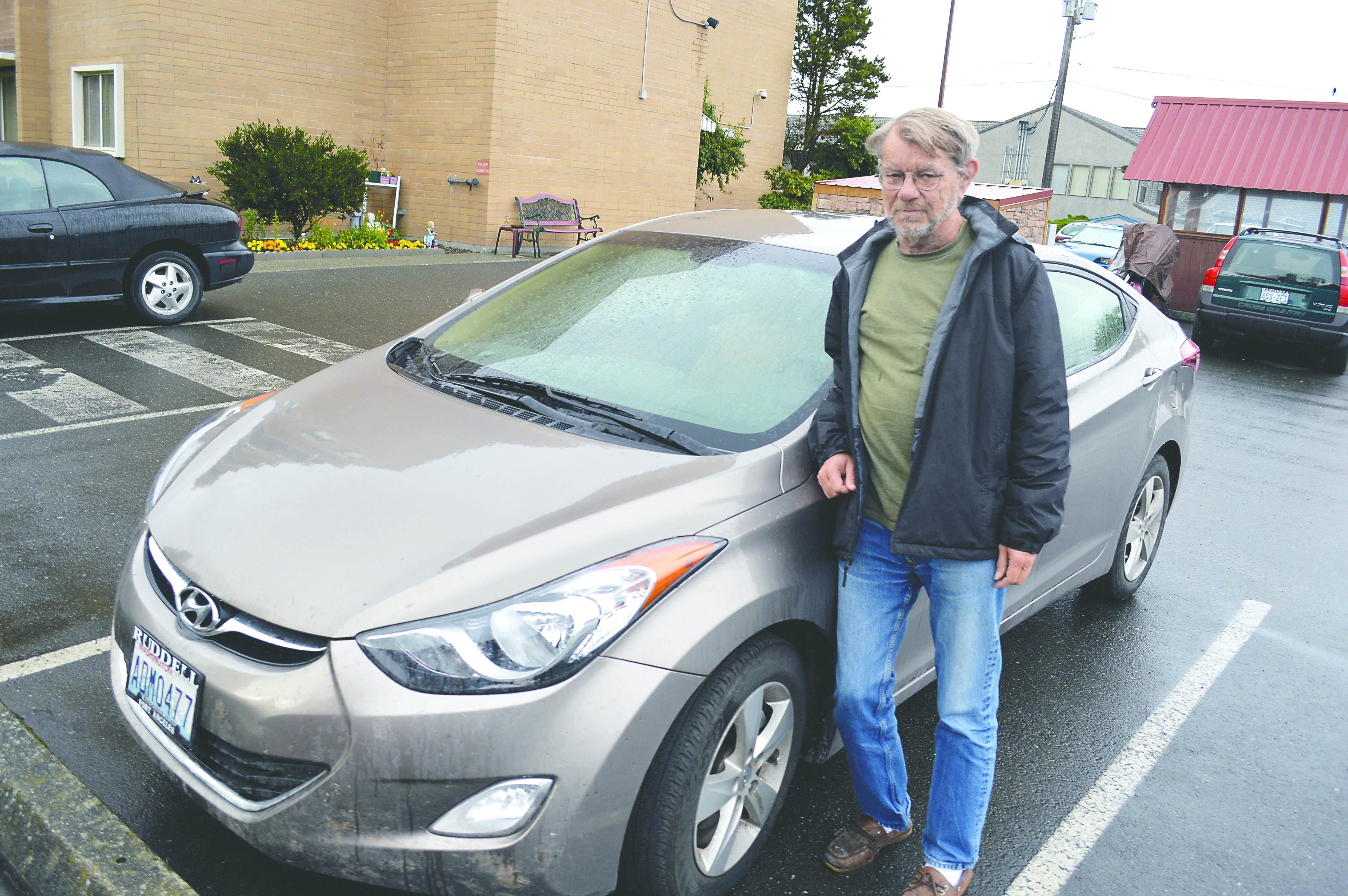 Alan Dawson stands with the Hyundai Elantra he drove through all of the 48 continental United States this summer