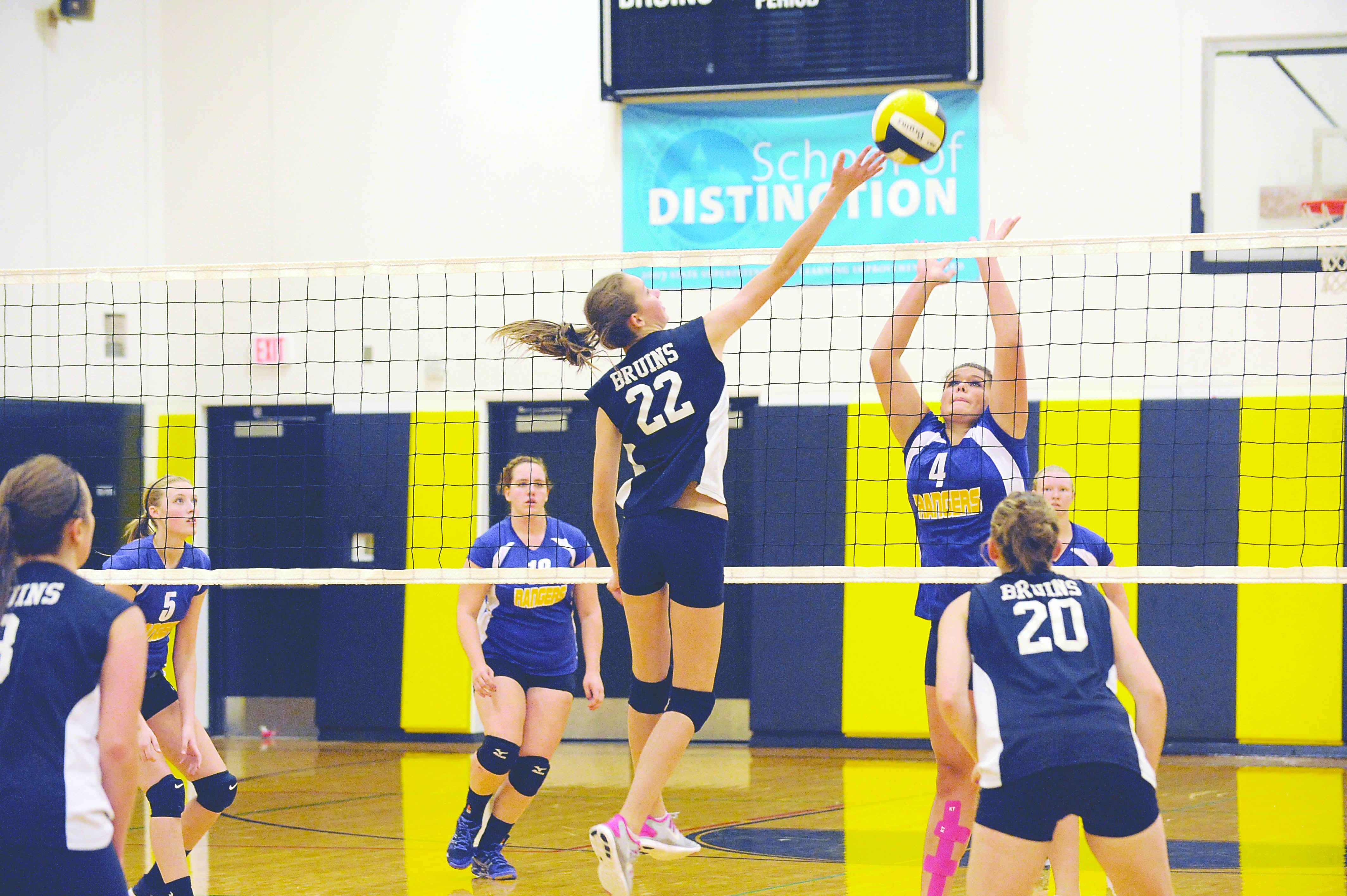 Clallam Bay's Molly McCoy (22) challenges Quilcene's Samantha Rae (4) at the net. Lonnie Archibald/for Peninsula Daily News