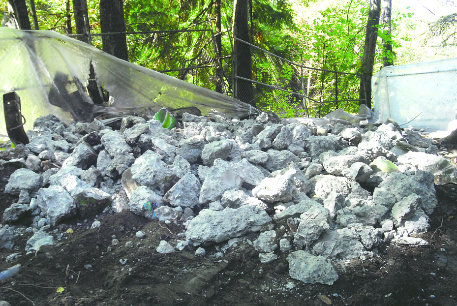 A pile of rubble is all that remains of what was once a concrete abutment along a side stream near the Dungeness River in Sequim. Keith Thorpe/Peninsula Daily News