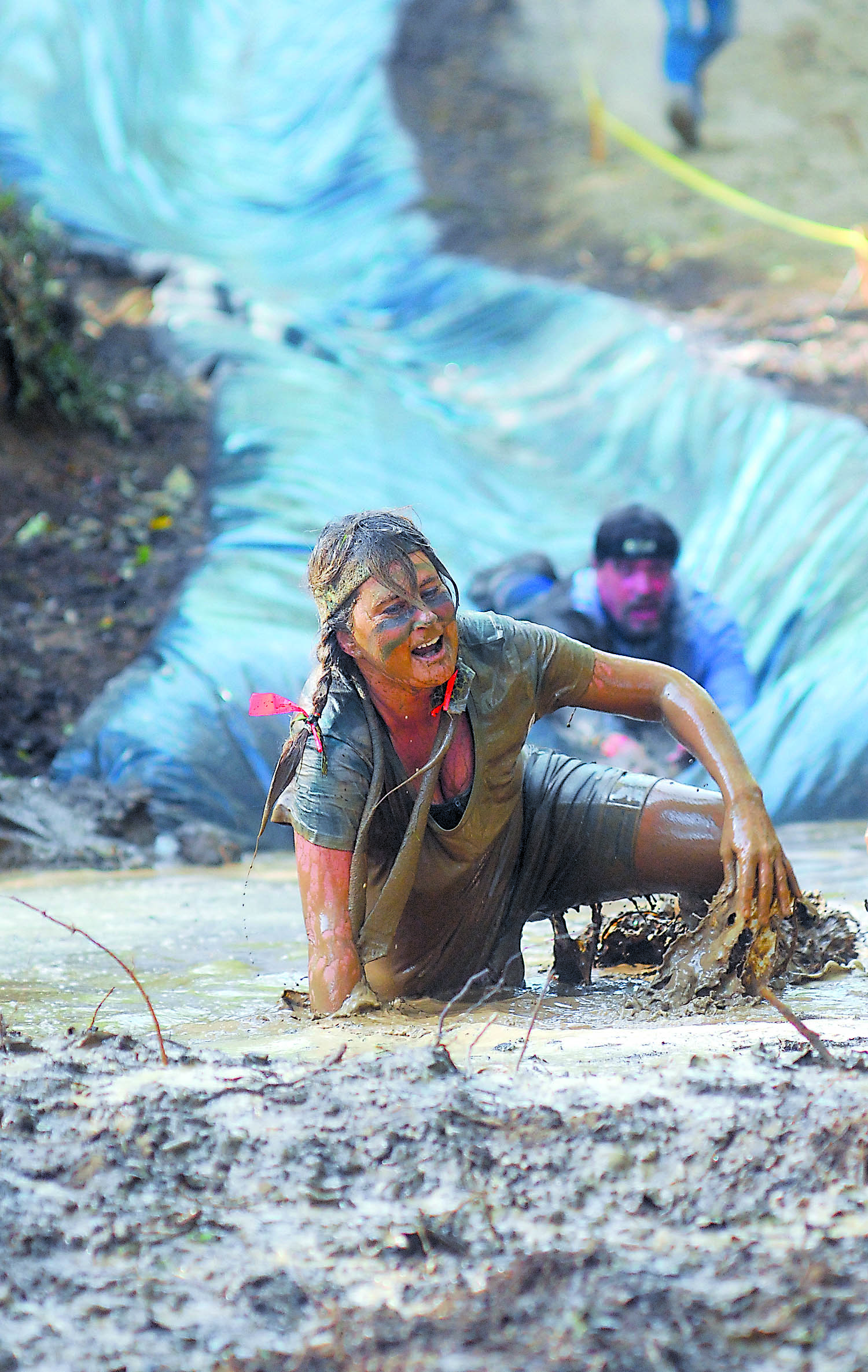 Casi Fors of Port Angeles emerges from a giant mud puddle after sliding down a hillside on a water slide during the inaugural Run A Muck Challenge in Port Angeles. Keith Thorpe/Peninsula Daily News