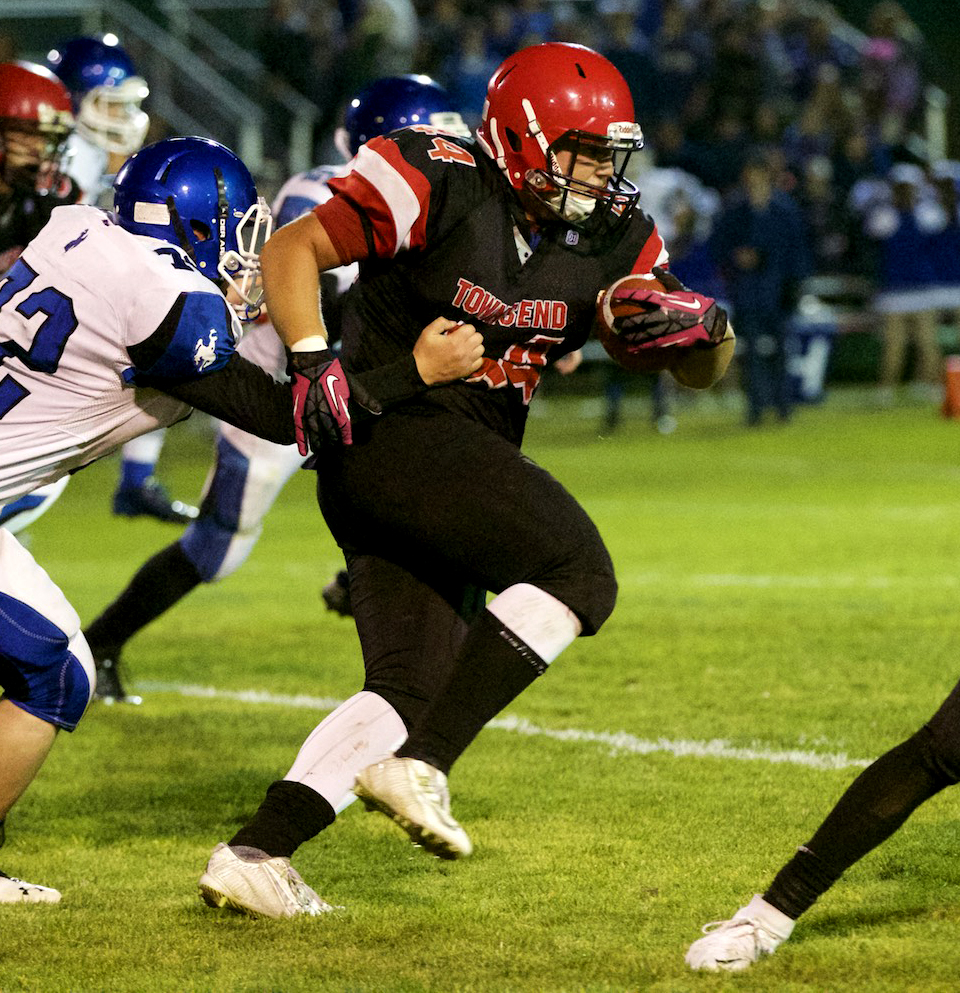 Port Townsend's Wesley Wheeler breaks a tackle and charges ahead for more yards during the Redhawks' 58-0 win over Chimacum at Memorial Field. Steve Mullensky/for Peninsula Daily News