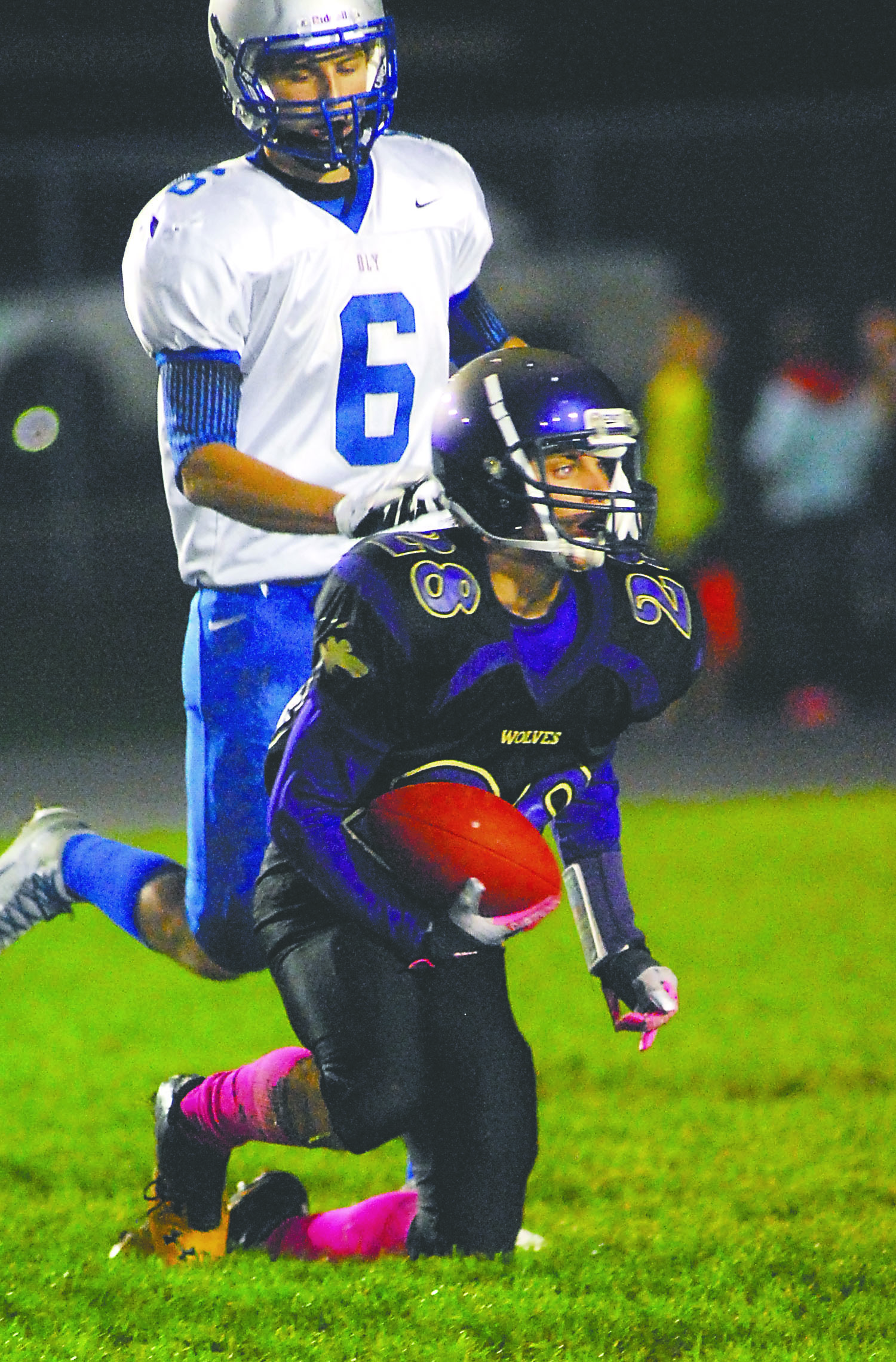 Sequim’s Matthew Sierra (28) looks up after making a catch in front of the defense of Olympic’s Joel Gesicki. Photo -- Keith Thorpe/Peninsula Daily News