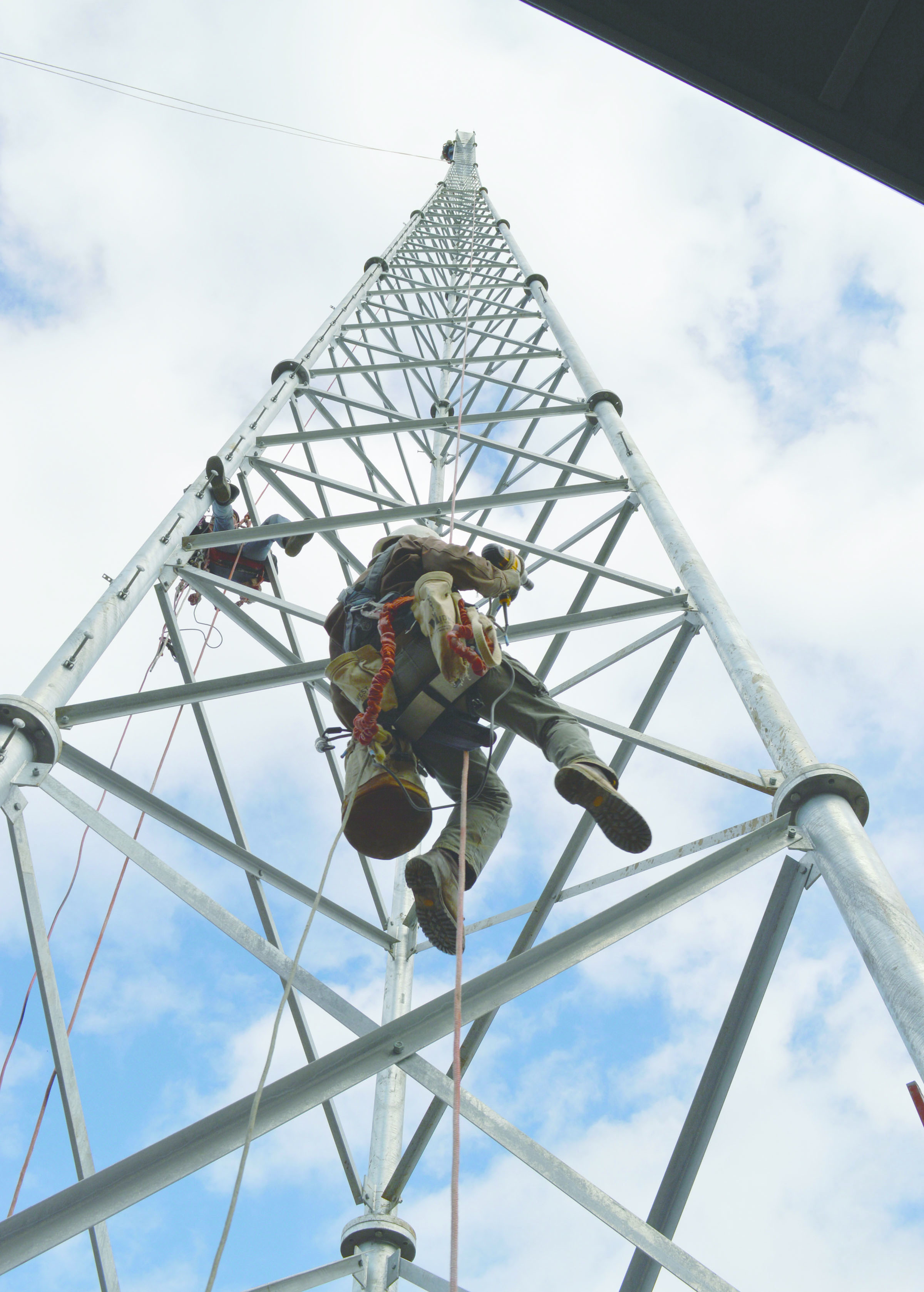 Workers with the North Star Broadcasting Co. tighten bolts on KSQM’s new 155-foot transmission tower Monday.  -- Photo by Joe Smillie/Peninsula Daily News