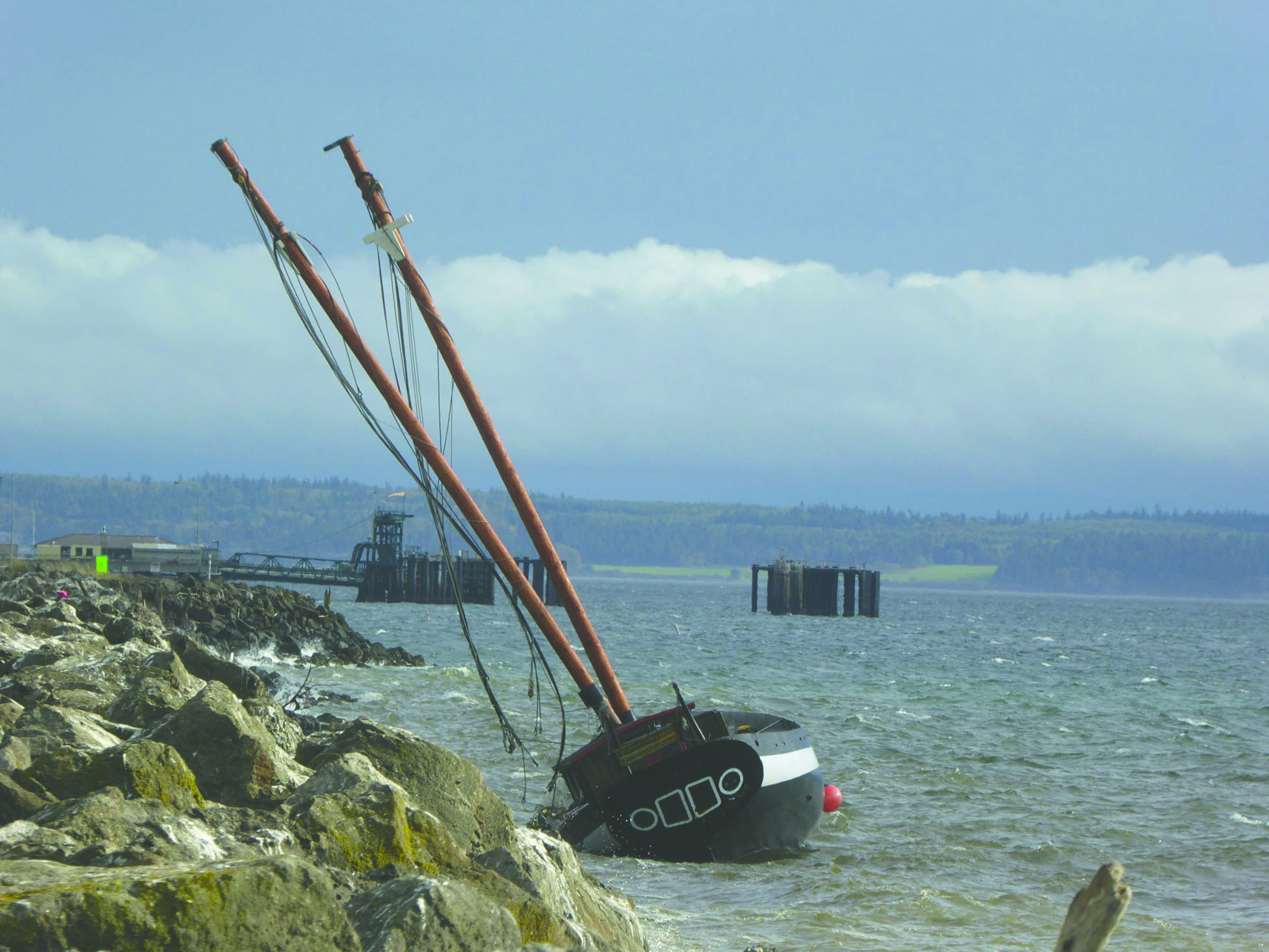 The schooner Phoenix remains trapped on the Port Townsend Boat Haven breakwater