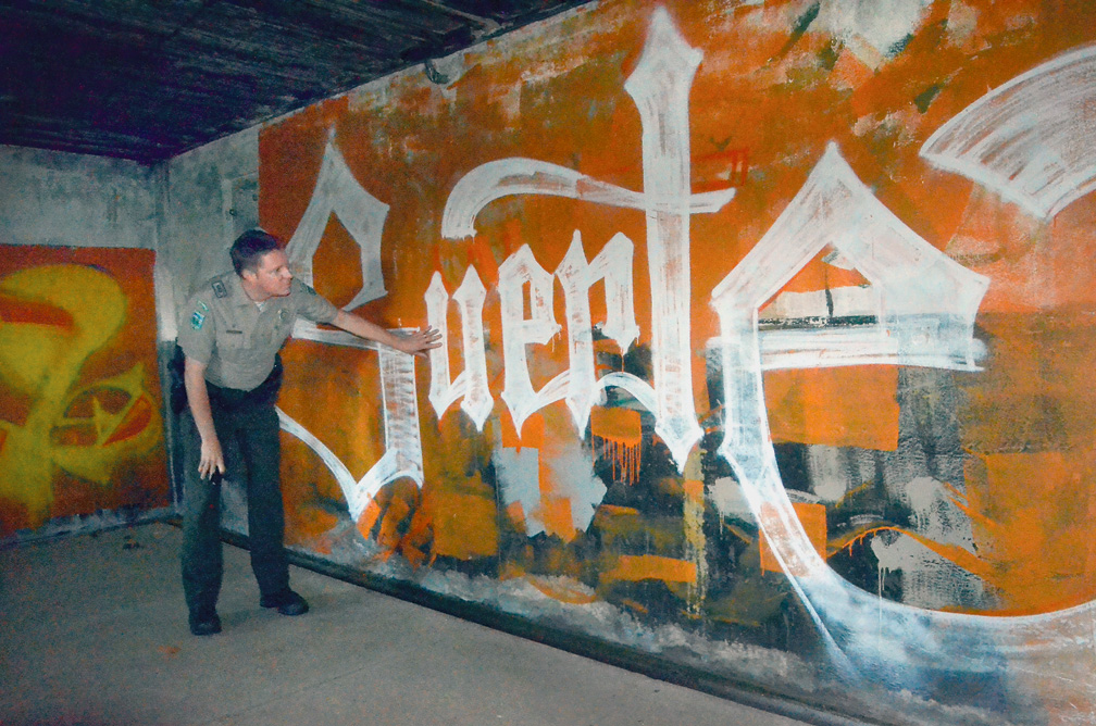 Fort Worden State Park Manager Brian Hageman inspects the graffiti damage from vandals who were arrested Oct. 5. Charlie Bermant/Peninsula Daily News