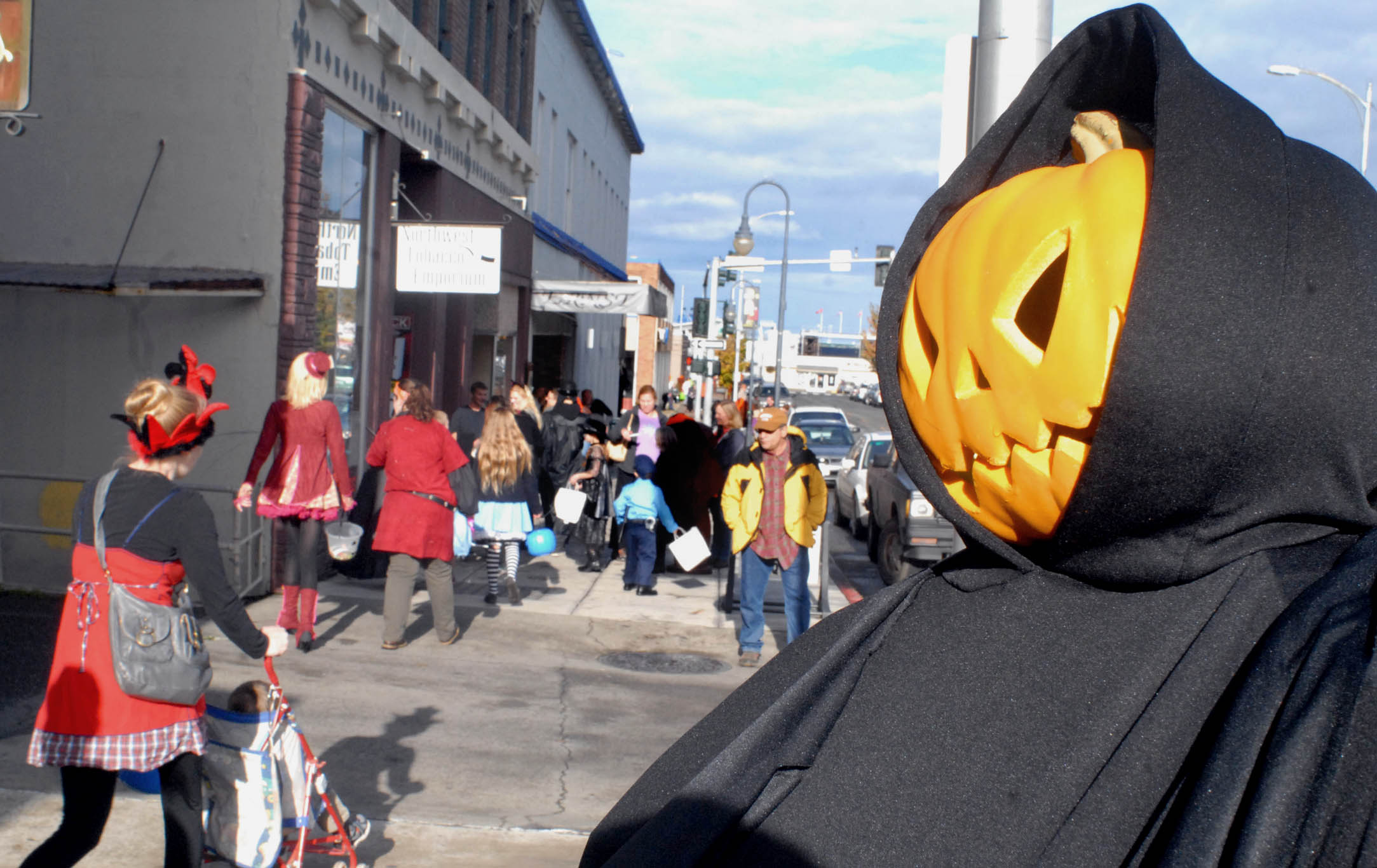 A sculpture-turned-goblin looks over trick-or-treaters on Laurel Street in downtown Port Angeles during Halloween festivities in 2014. Keith Thorpe/Peninsula Daily news