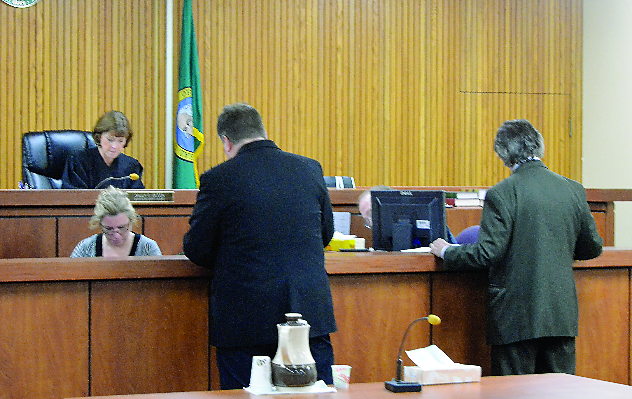 Kitsap County Superior Court Judge Sally Olsen hears arguments from prosecutor Chris Ashcraft and defense attorney Richard Davies at a pretrial hearing in the murder retrial of Michael J. Pierce on Friday. Clerk Jami Hetzel is in the foreground.  -- Photo by Charlie Bermant/Peninsula Daily News