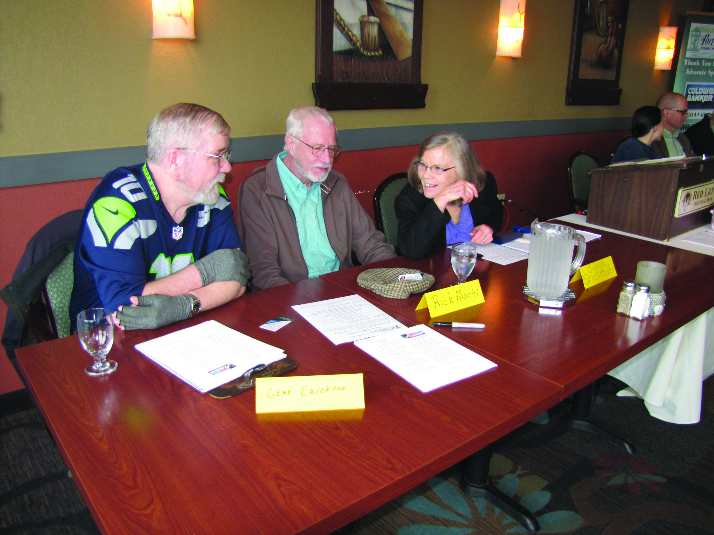 Candidates for Port Angeles School Board talk while they await a final candidate forum at the Port Angeles Regional Chamber of Commerce meeting Monday. From left are Gene Erickson