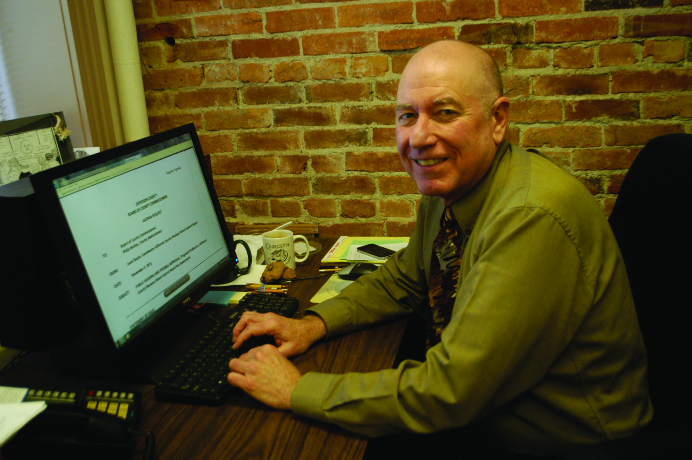 Jefferson County Commissioner David Sullivan reviews this week's meeting agenda Monday in his office. One of the items on the agenda