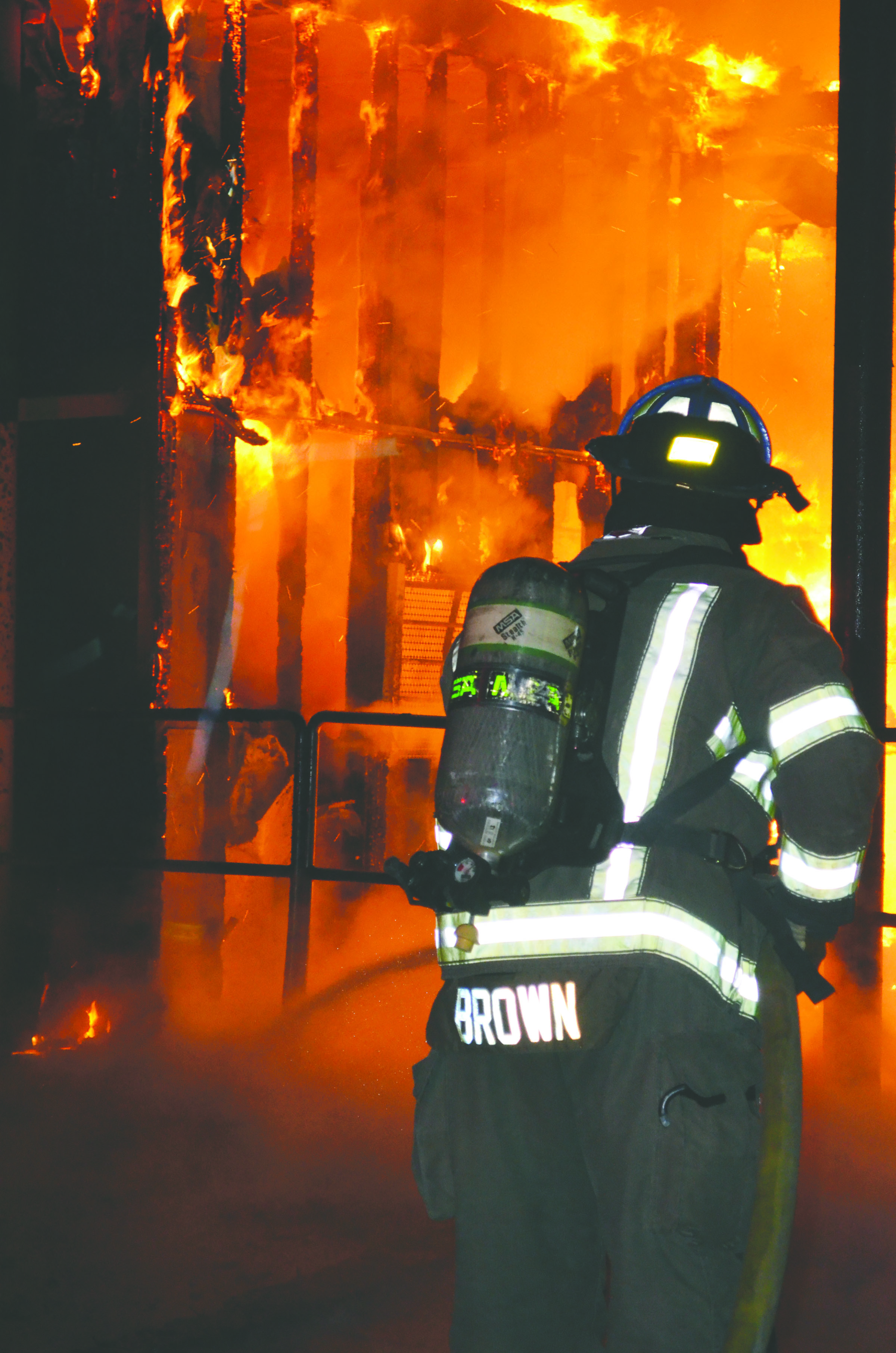 A firefighter battles the Blue Mountain Transfer Station blaze Sunday night.  -- Clallam County Fire District No. 3 photo