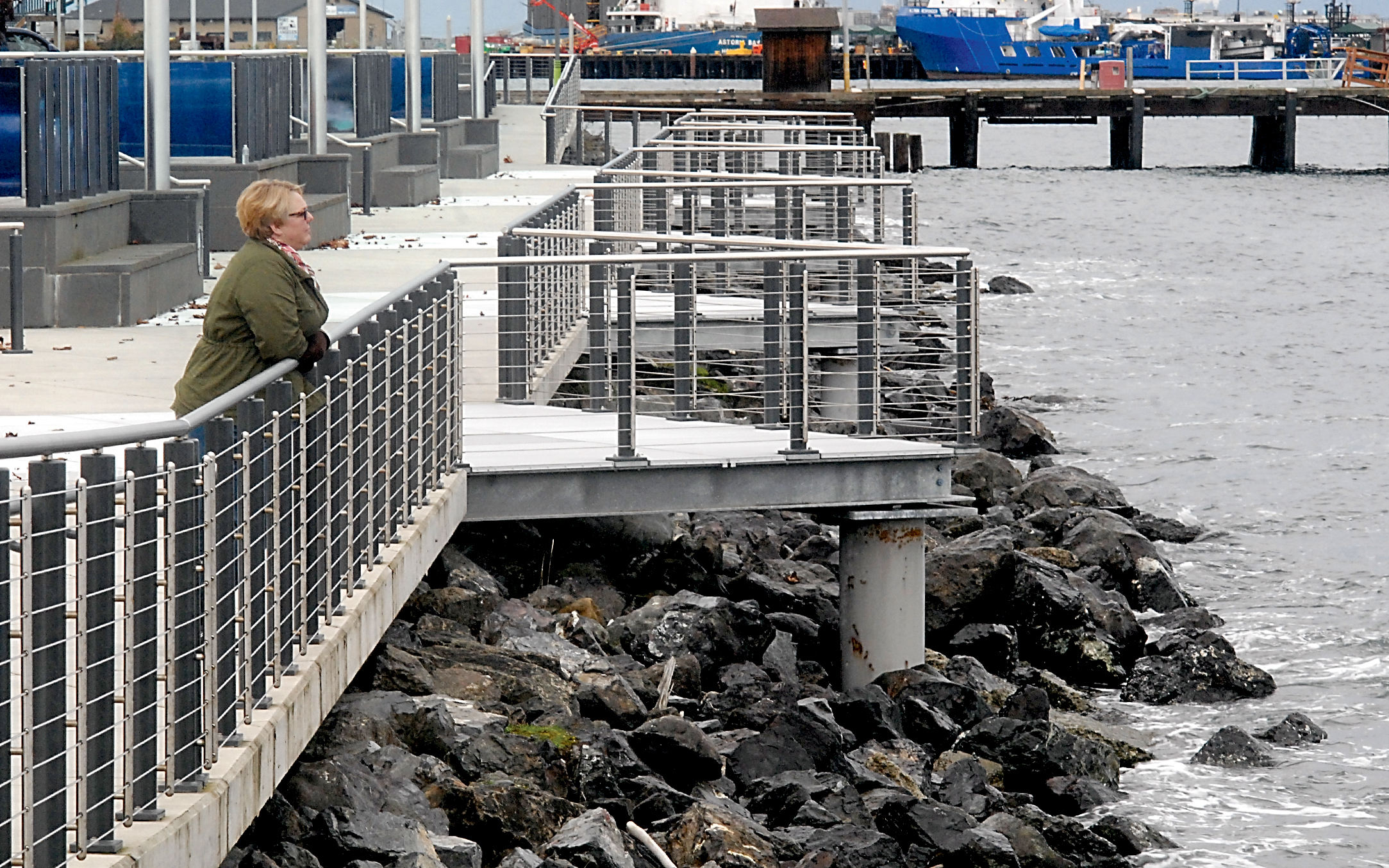 Janet Vaughan of Port Angeles looks out at the harbor from the esplanade walkway in Port Angeles on Thursday. A recent study suggests Port Angeles and surrounding areas may be better able to handle the effects of climate change