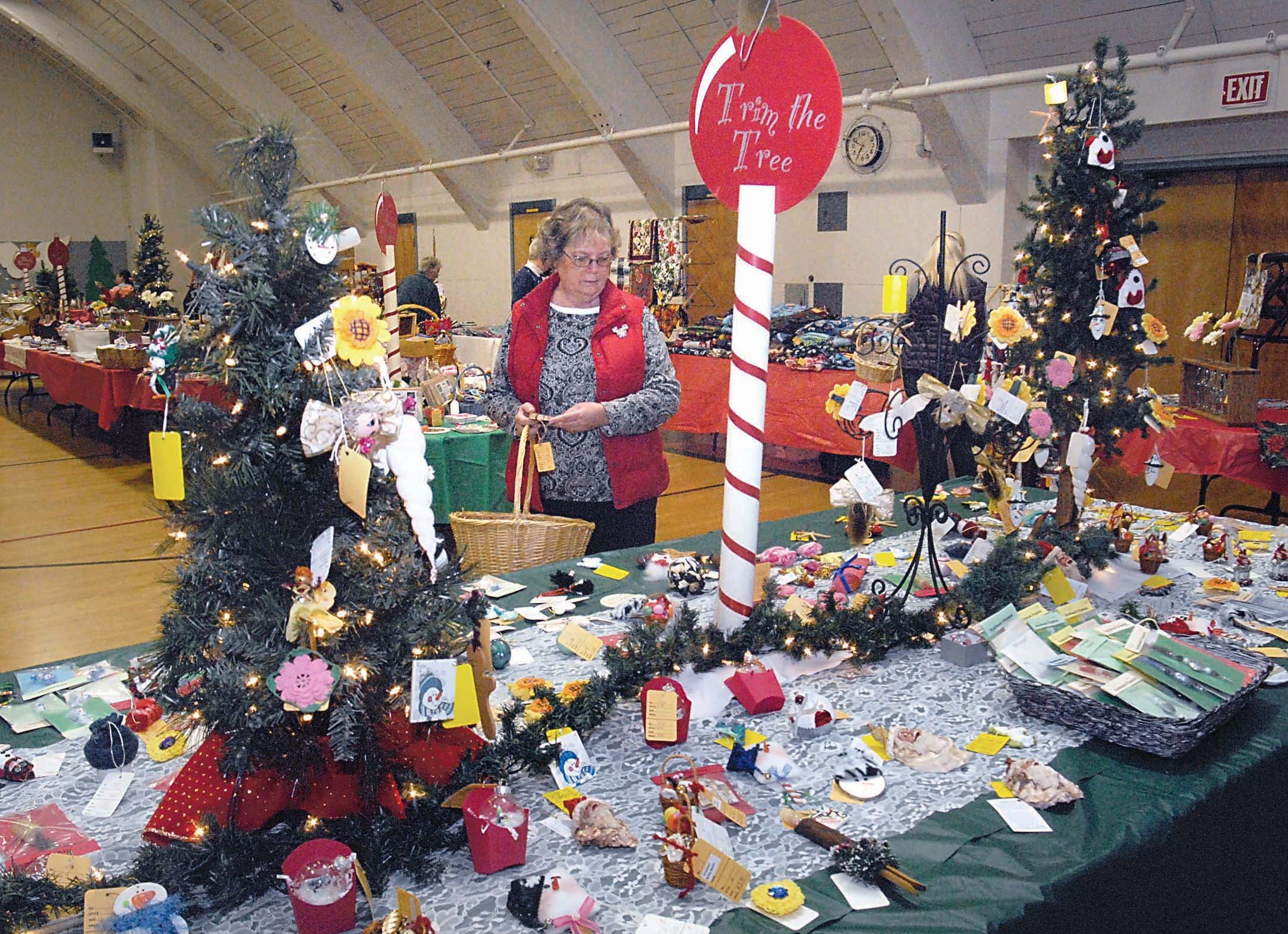 Pam Kiteley of Port Angeles looks over a table filled with homemade crafts at last year's annual Christmas Cottage craft fair at Vern Burton Community Center in Port Angeles. The event