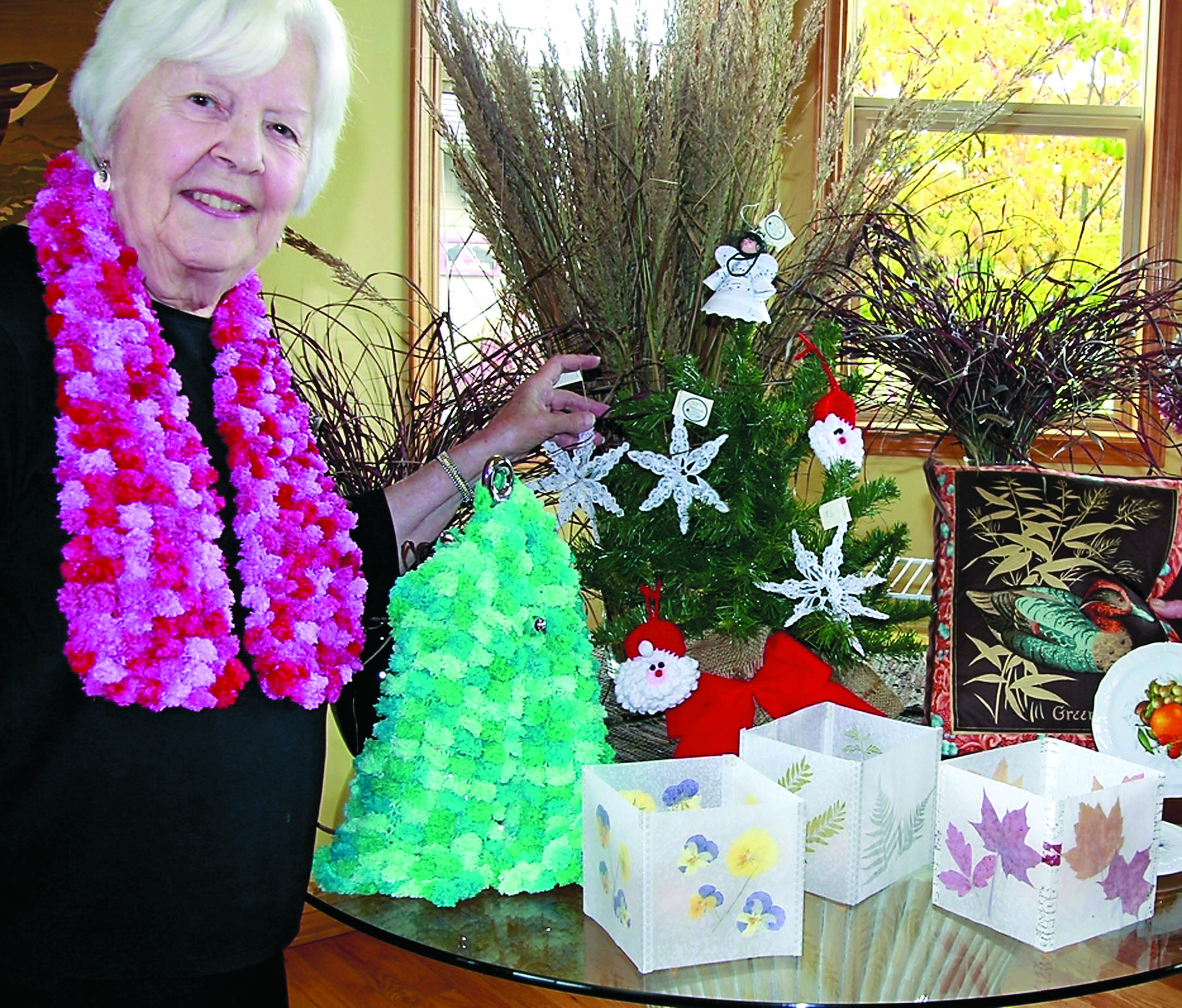 Dorothy Shreffler displays a few of the gifts that will be for sale at the Dungeness River Audubon Center's sixth annual holiday fair. Sue Chickman