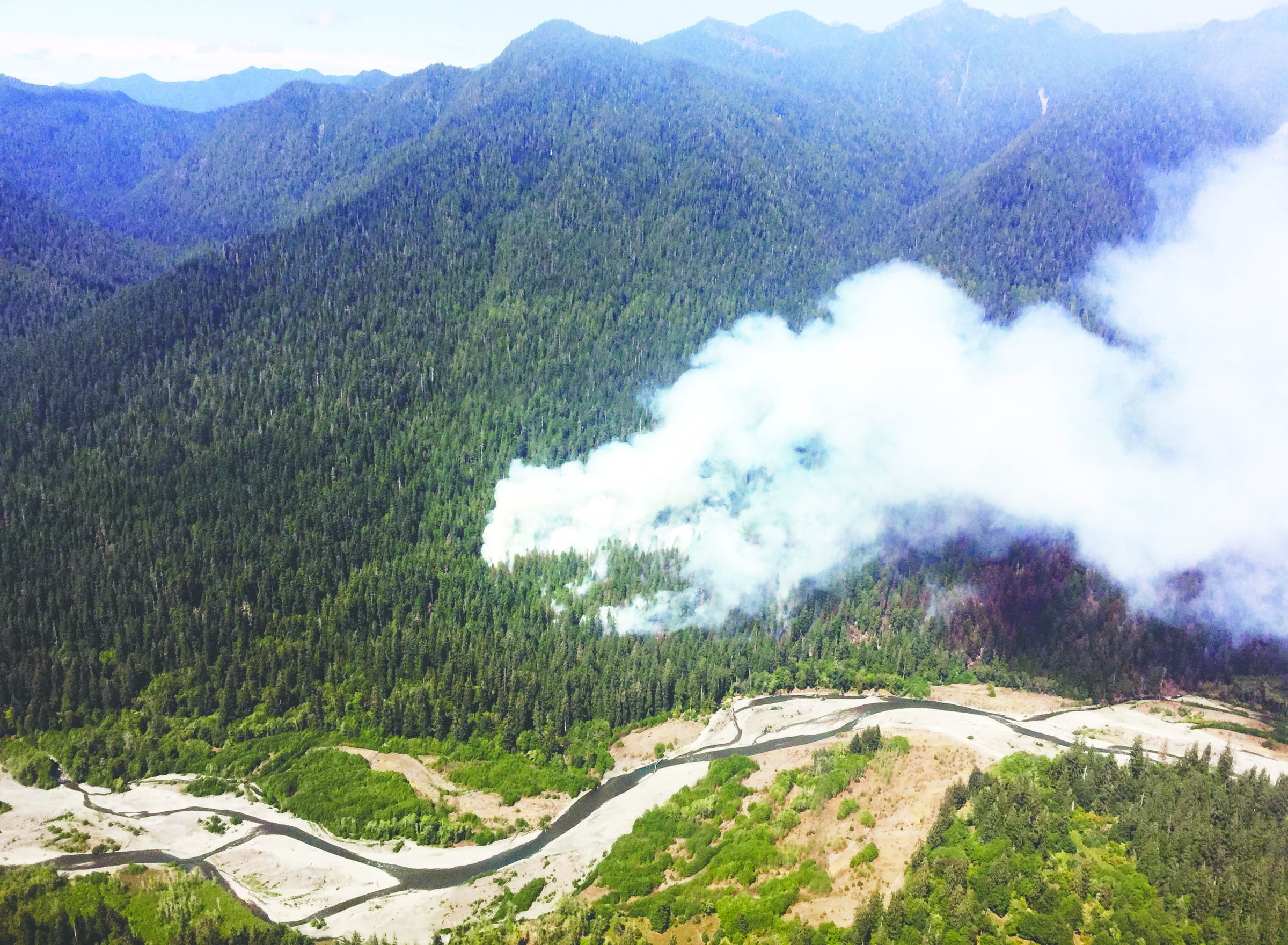 The Paradise Fire sends up smoke in the Queets River valley in August. National Park Service