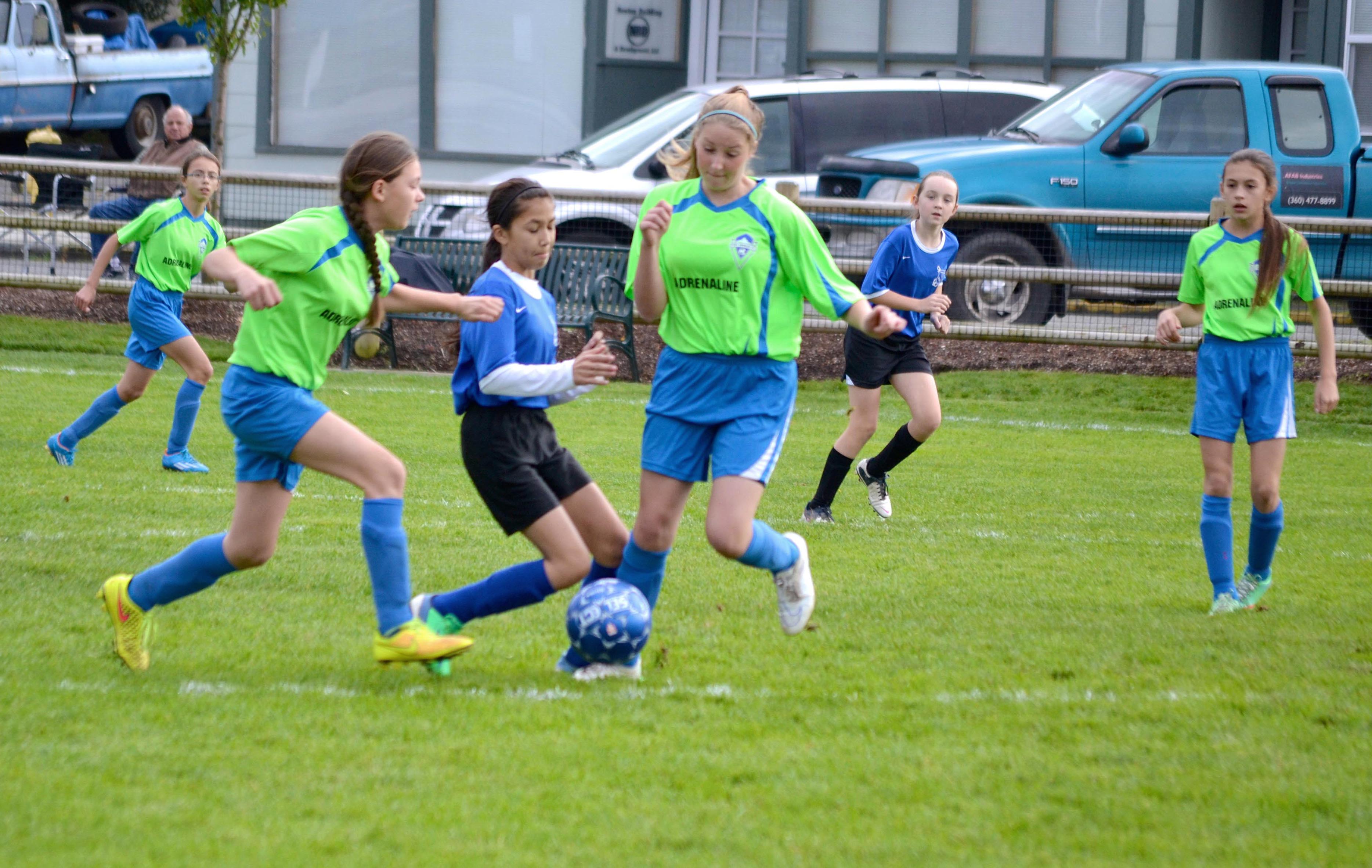 Adrenaline's Jada Cargo and Kyrsten McGuffey team up to steal the ball from a Bremerton player.