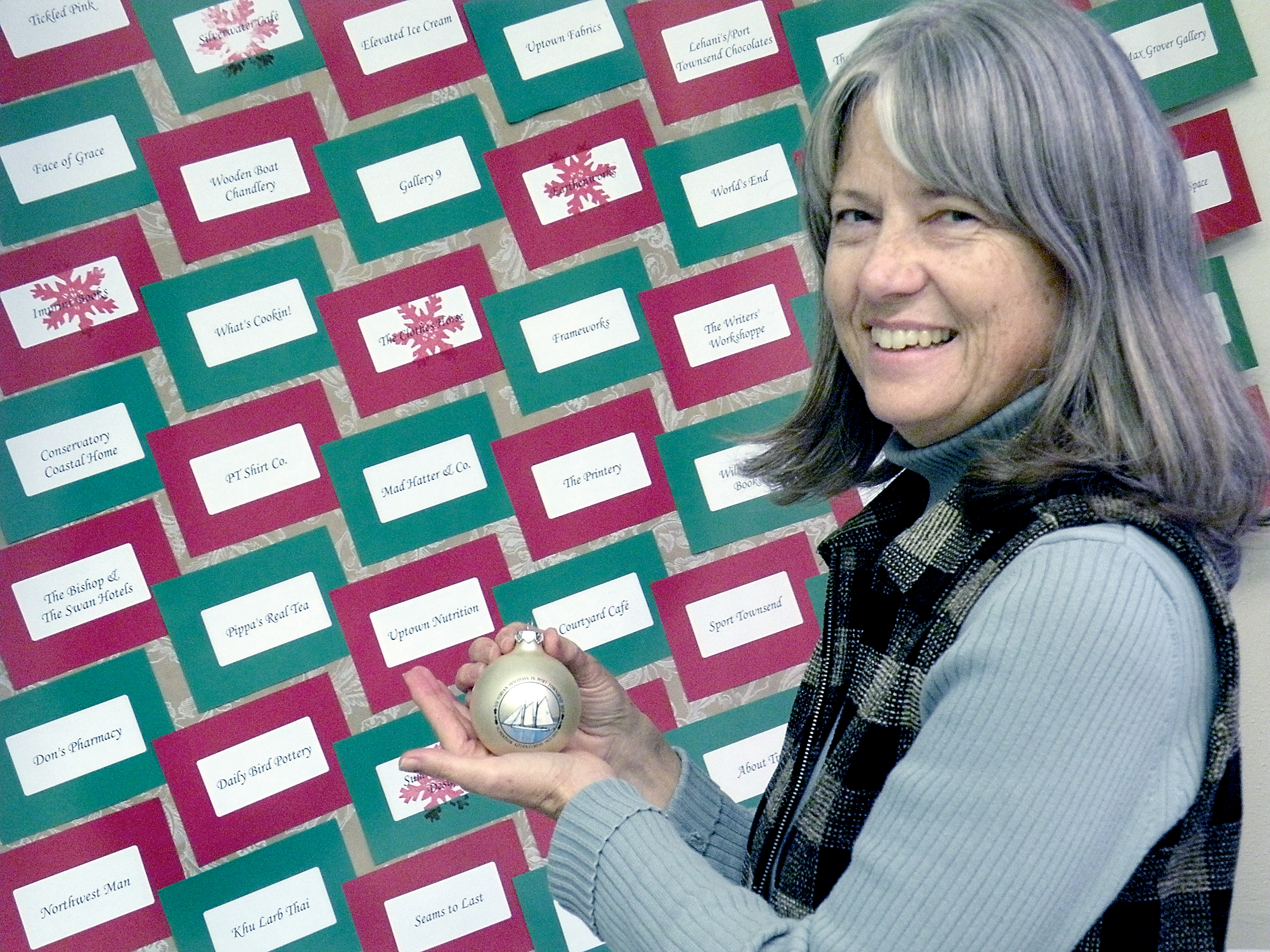 Elizabeth Becker of Seaport Photography of Port Townsend holds the Port Townsend Main Street's limited-edition ornament that bears a photograph she took of the schooner Adventuress. Port Townsend Main Street