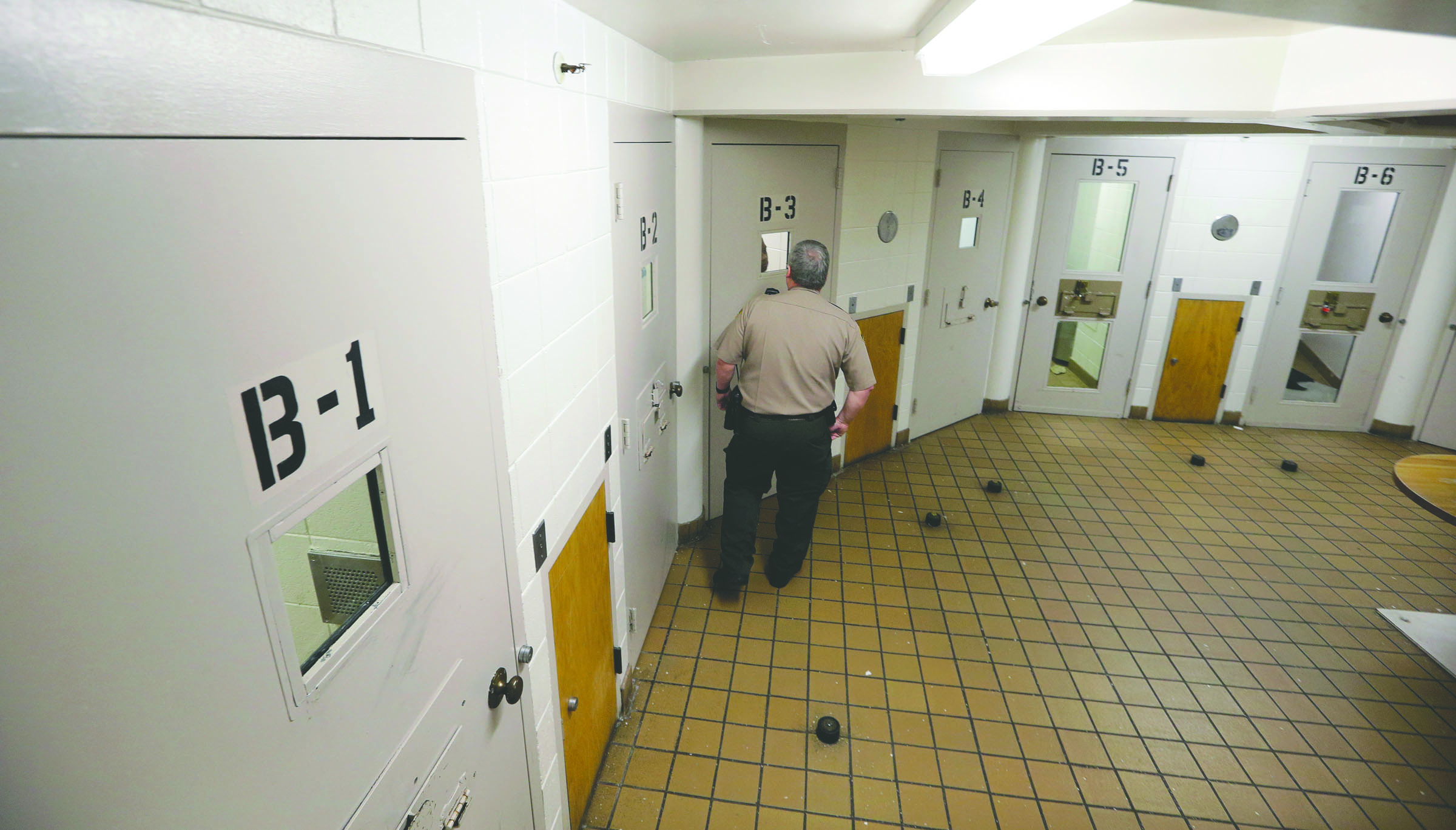 Corrections Deputy Kent Wales looks in on inmates in the psychiatric unit of the Pierce County Jail in Tacoma in October. According to recently released documents