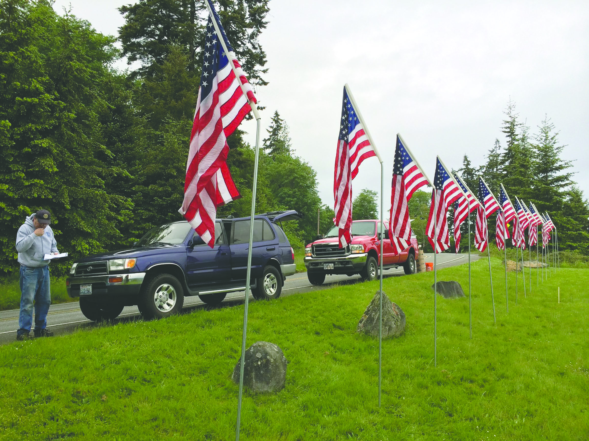 Rotarian John Ericson with American flags placed by the East Jefferson Rotary Club at The Inn at Port Ludlow Resort for Veterans Day. The theft of 13 of the flags placed by the club could have an impact on the number of scholarships the group can award. East Jefferson Rotary Club
