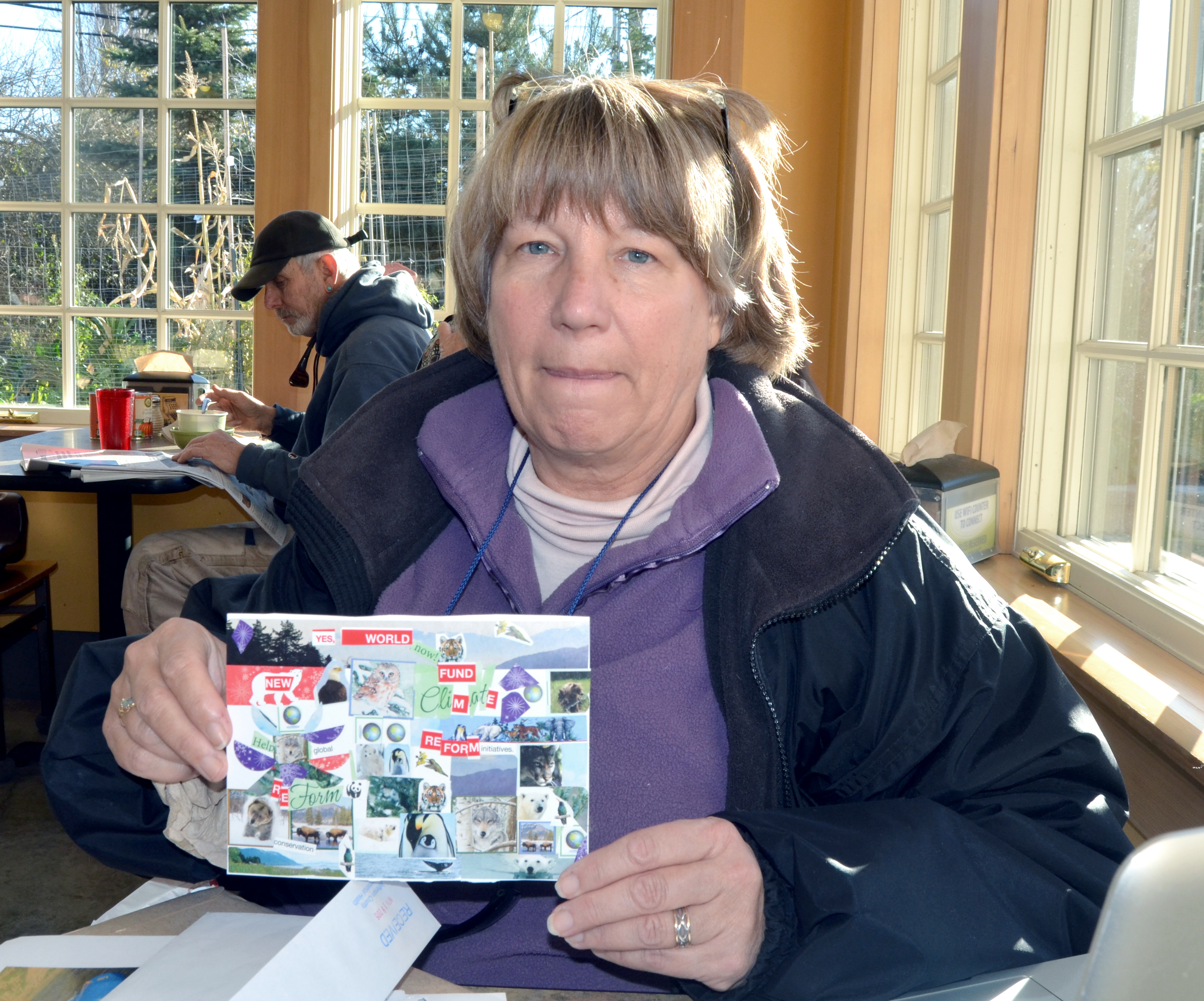 Climate change activist Laura Tucker shows some of the cards she is bringing to a conference in Paris