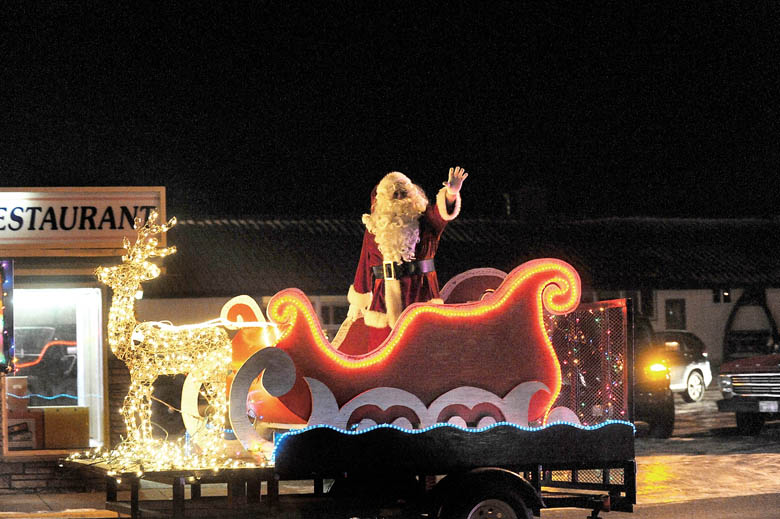 Santa waves from his carriage as last year's Twinkle Light Holiday Parade proceeds in Forks. Lonnie Archibald/for Peninsula Daily News