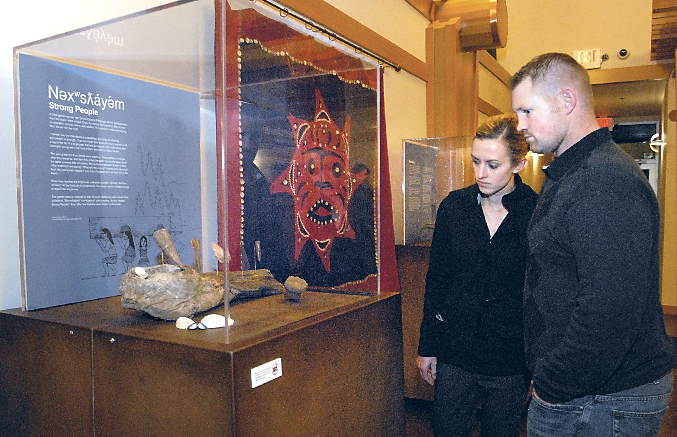 Jessica and Mike Tade of Sequim look at a display of Klallam artifacts during their first public showing at the Elwha Heritage Center in Port Angeles. Keith Thorpe/Peninsula Daily News