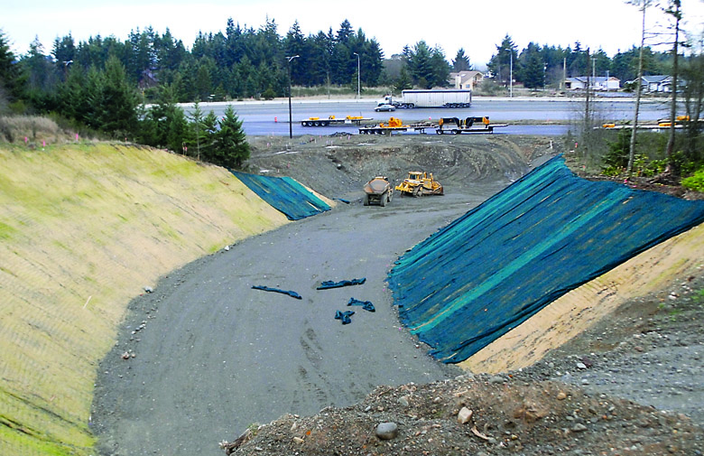 Traffic flows along U.S. Highway 101 on Thursday past the site of what will become a highway underpass near Deer Park Road east of Port Angeles. Keith Thorpe/Peninsula Daily News