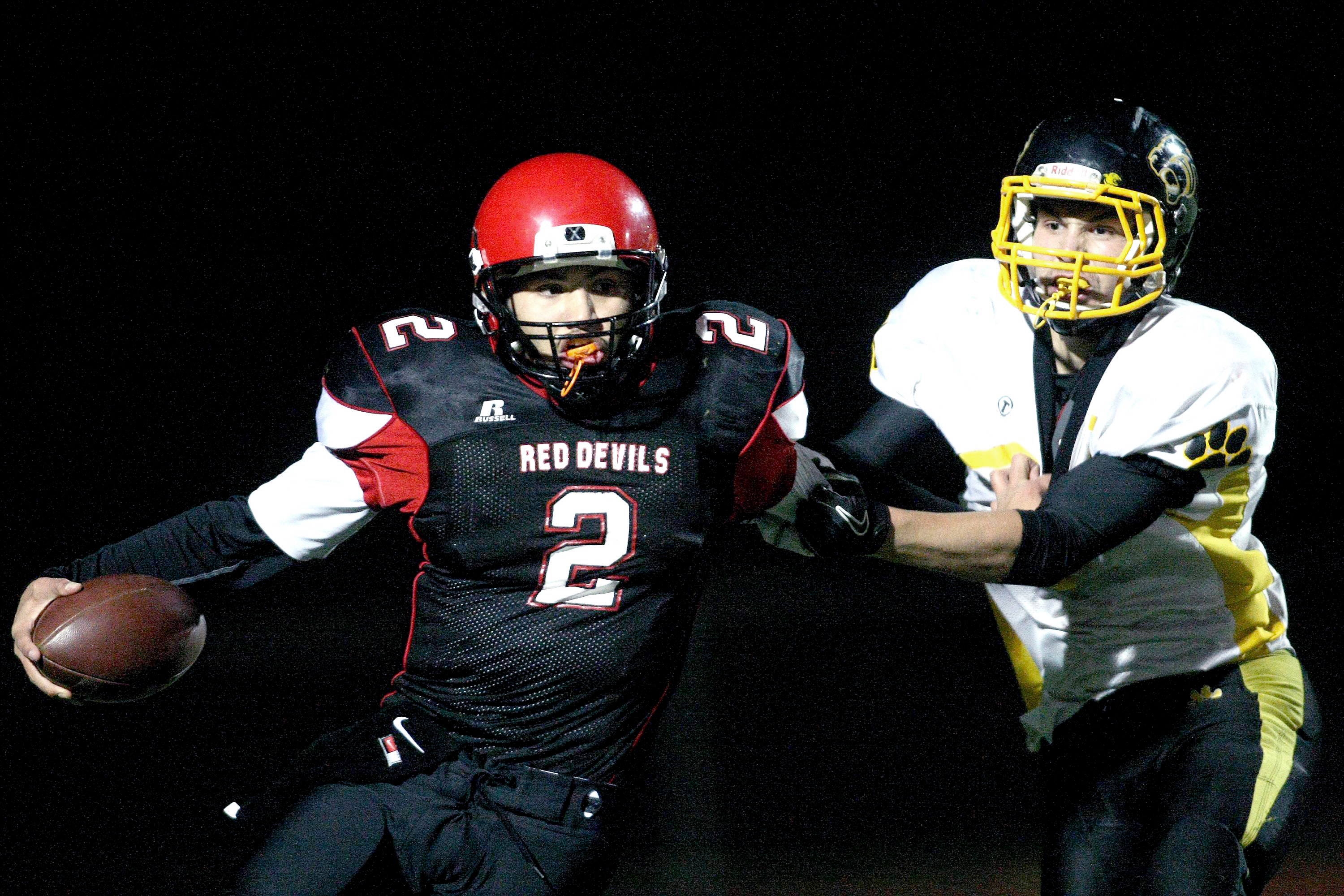 Neah Bay's Josiah Greene (2) eludes Cusick's Alec Bluff to avoid a sack during the state quarterfinal at Silverdale Stadium last month. Green has been named 1B state player of year for the second time. David Willoughby/for Peninsula Daily News