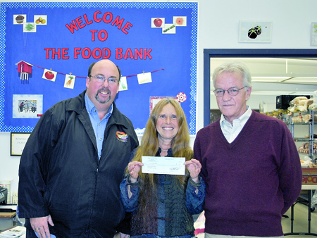 Port Townsend Food Bank Director Shirley Moss accepts a $500 donation from Amalgamated Transit Union Local 587 Field Supervisor/Shop Steward Lloyd Eisenman