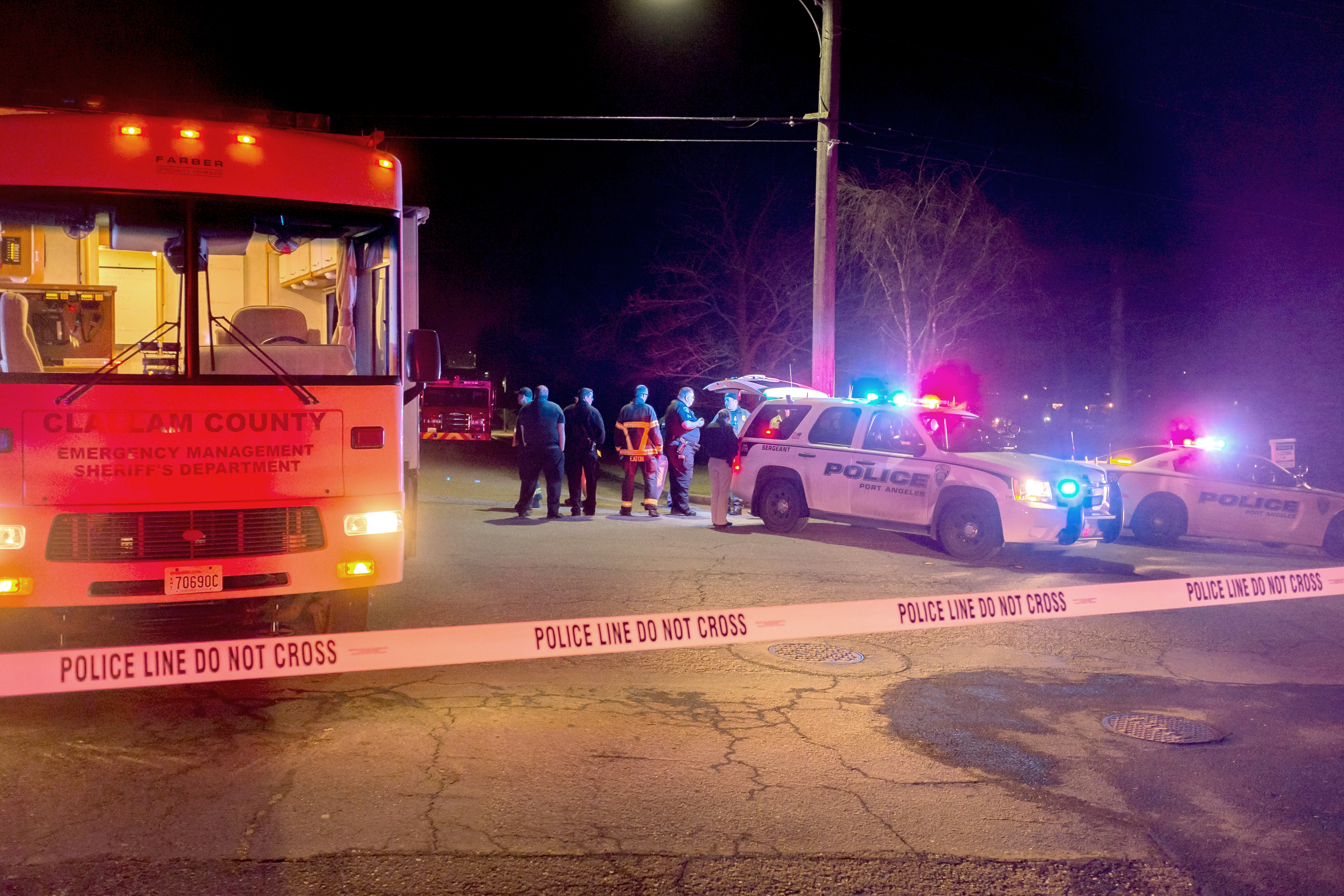 The Port Angeles police and the Clallam County Sheriff's Office mobile command post block access at Eighth and I streets Monday night in Port Angeles. Patrick Downs