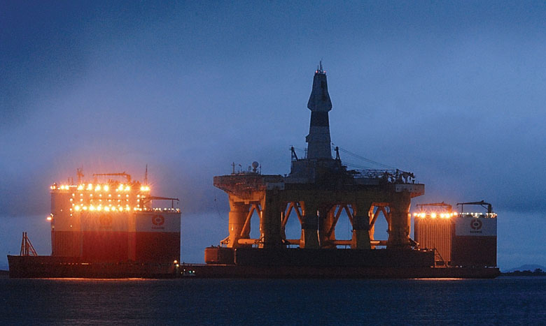 The oil drilling platform Polar Pioneer sits atop the heavy-lift transport ship Dockwise Vanguard in Port Angeles Harbor on Thursday morning. It left Thursday night. Keith Thorpe/Peninsula Daily News