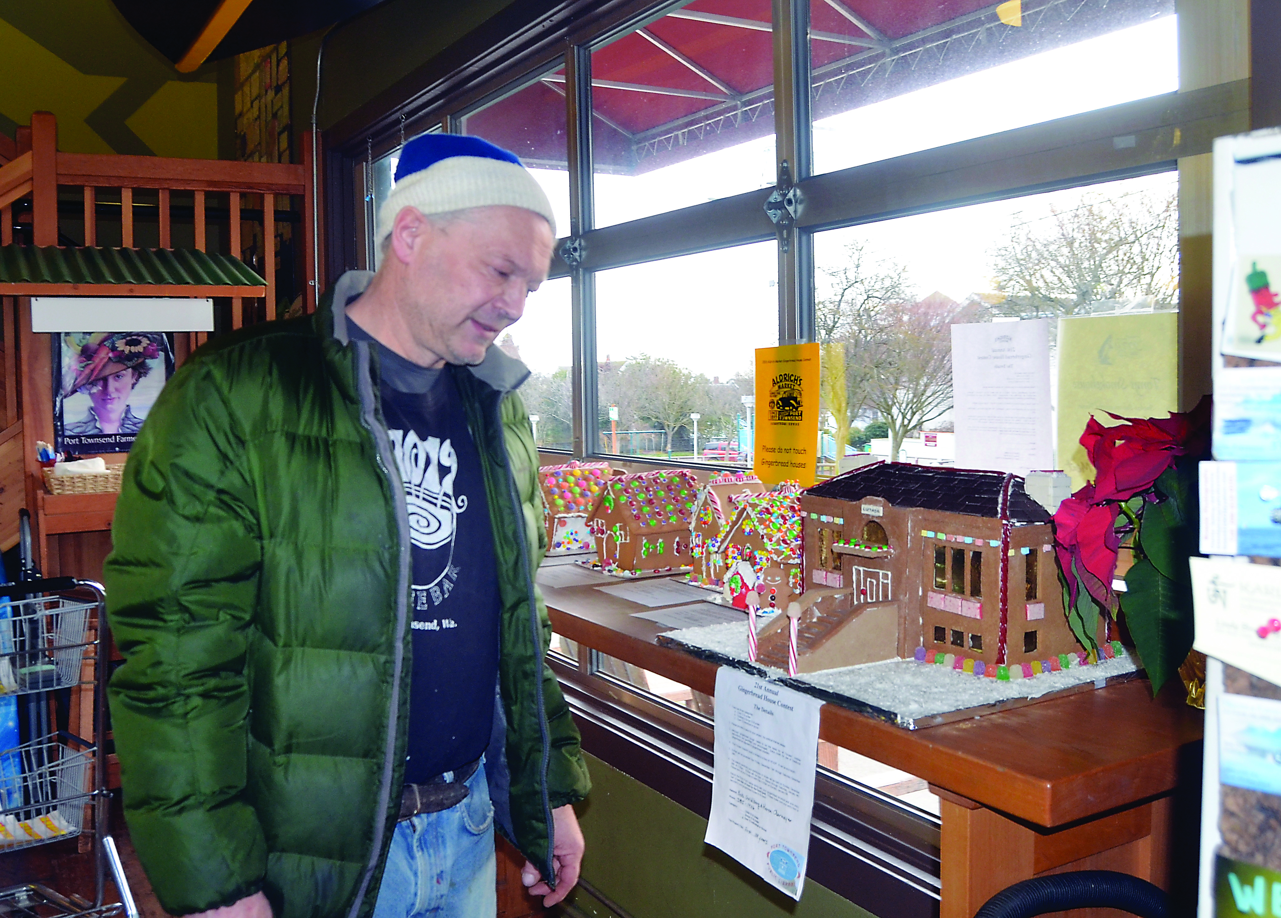 Mike Nissen checks out some of the entries in the annual Aldrich's Market gingerbread house contest. Prospective gingerbread artists have until Saturday to submit their best work