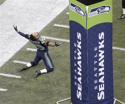 Seattle Seahawks free safety Earl Thomas kneels on the CenturyLink Field turf. —Photo by The Associated Press