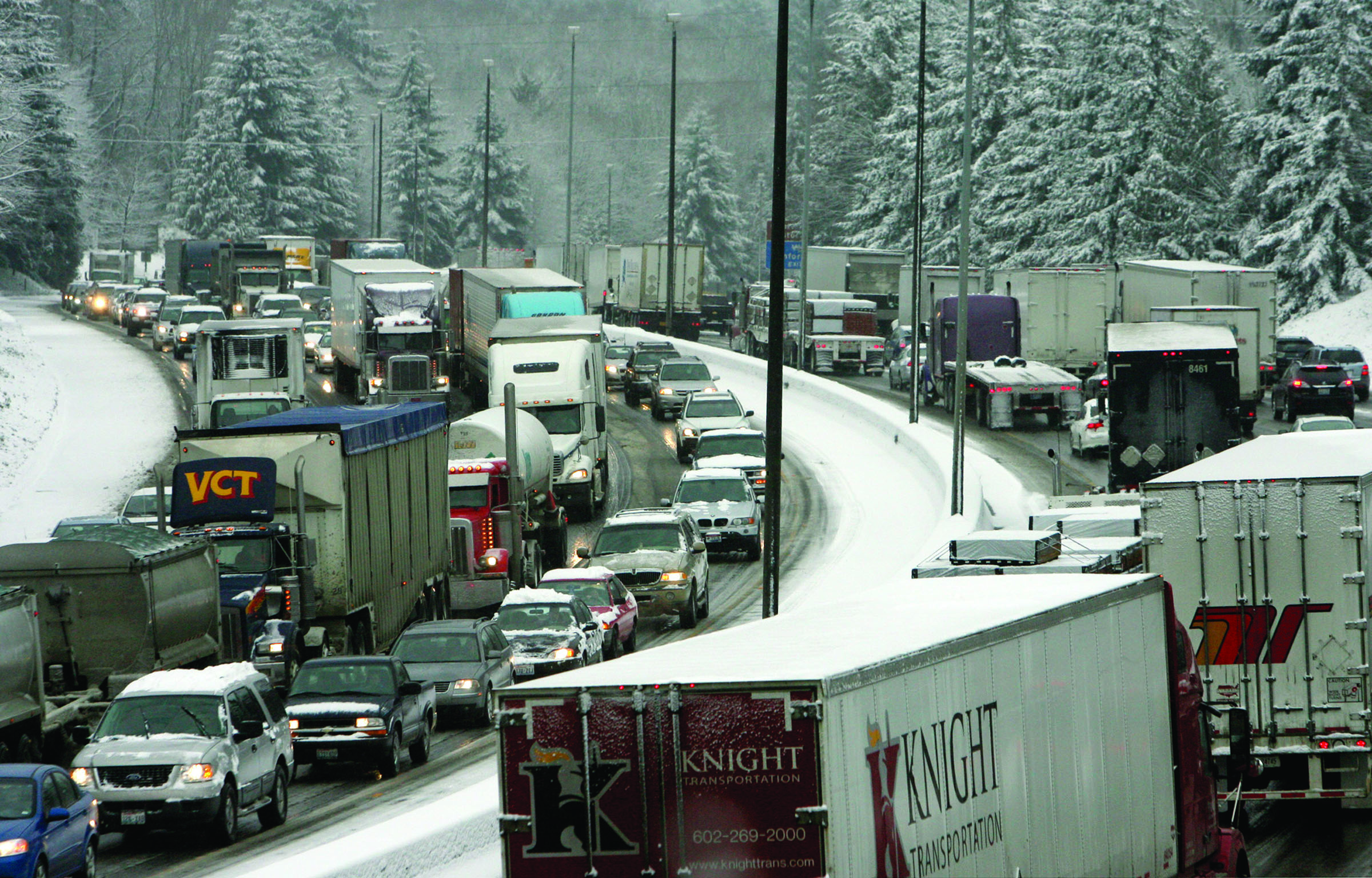 A snow storm leaves a commuting mess on Interstate 5 in Olympia in 2011. Many of the chemicals spread on highways to help winter drivers can damage the environment. Researchers at Washington State University are working on environmentally friendly ways that use less salt. — The Associated Press